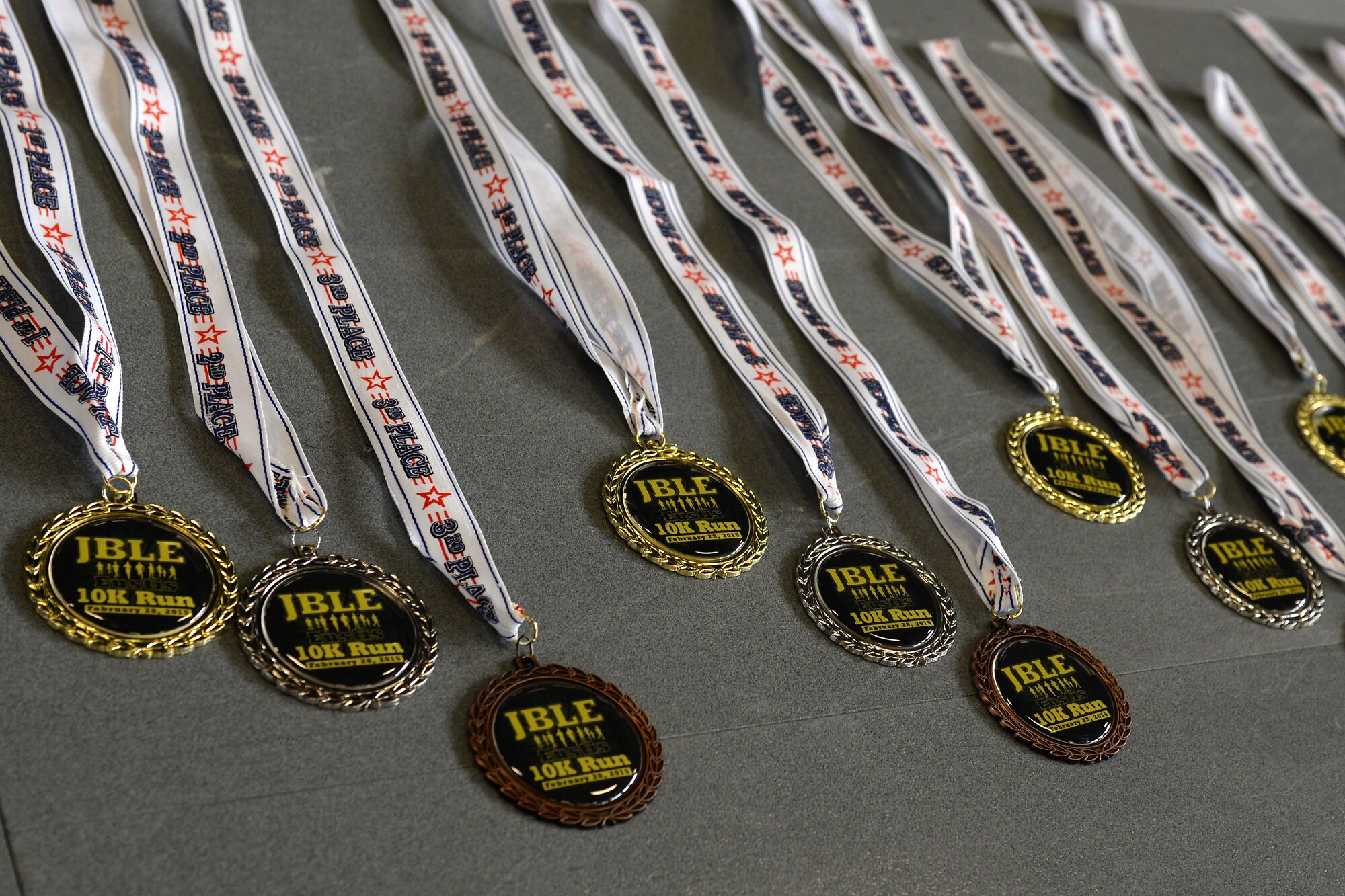 Medals were presented to the top three male and female runners in each age group after the 17th Annual Fort Eustis 10K run at Fort Eustis, Va., Feb. 28, 2015. Age groups ranged from 19 years and under to 65 years and older. (U.S. Air Force photo by Staff Sgt. Teresa J. Cleveland/Released)