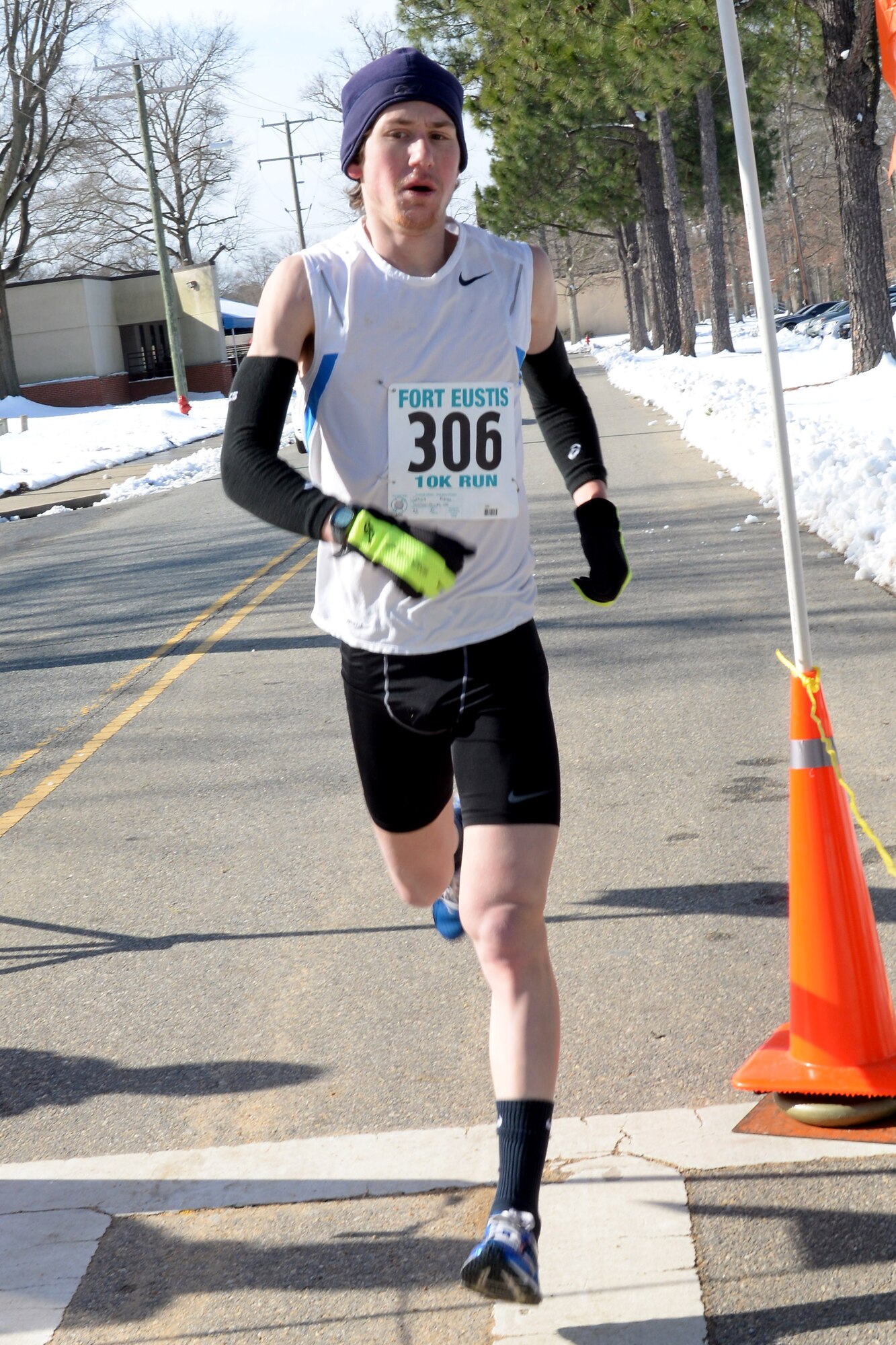 Ryan Conoy races across the finish line during the 17th Annual Fort Eustis 10K Run at Fort Eustis, Va., Feb. 28, 2015. Conoy was the first to cross the finish line with a run time of 36 minutes, 20 seconds. (U.S. Air Force photo by Staff Sgt. Teresa J. Cleveland/Released)