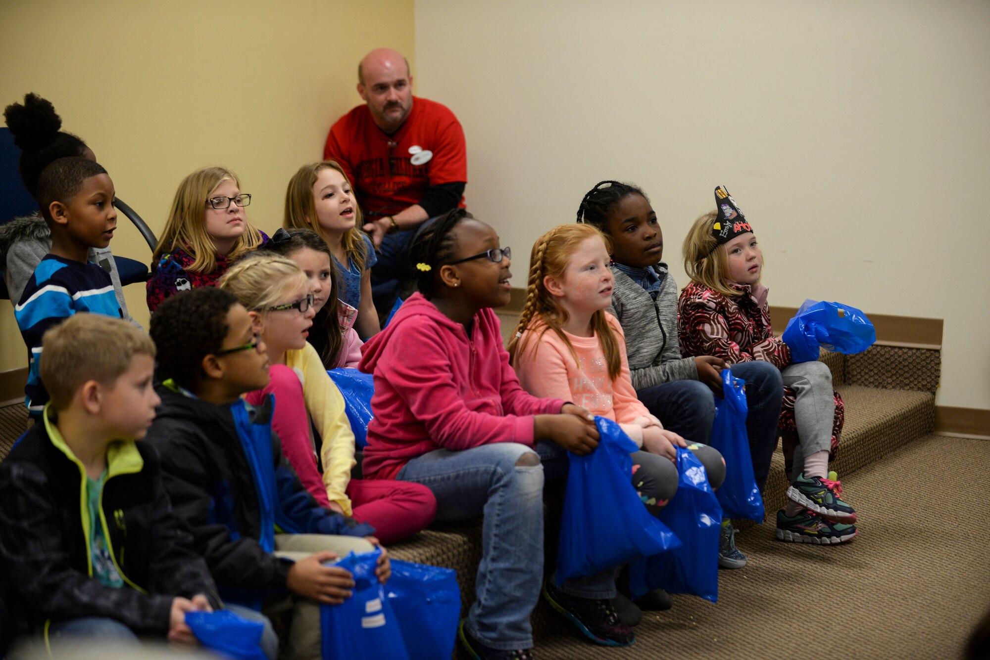 Moody Youth Programs children listen to the story of King Arthur during the Literacy Fair Feb. 26, 2015, at Moody Air Force Base, Ga. During the presentation the children also learned about medieval values and chivalry. (U.S. Air Force photo by Senior Airman Sandra Marrero/Released)

