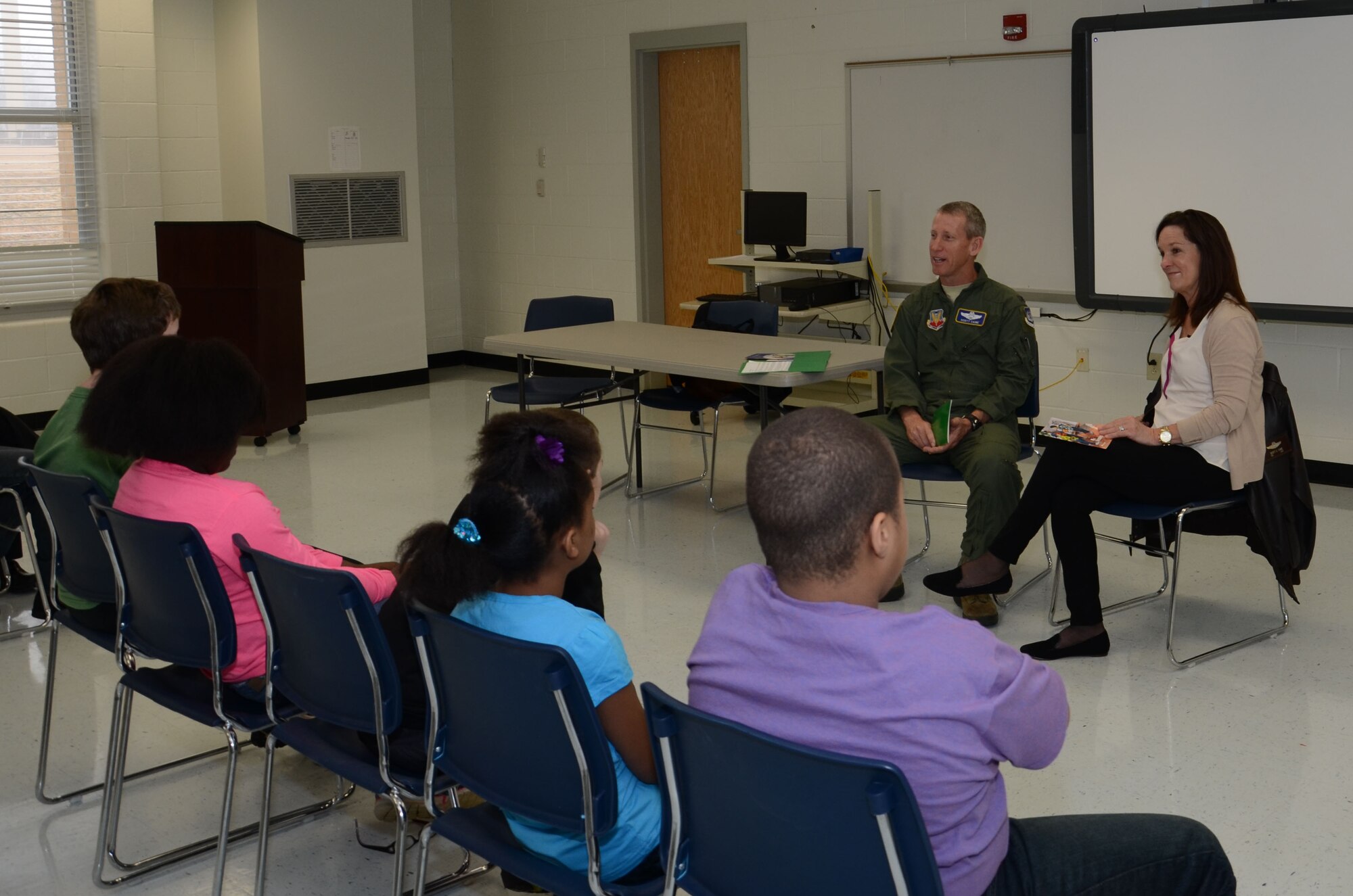 U.S. Air Force Col. Scott Caine, Ninth Air Force vice commander, and his wife, Pam, read to a group of fourth- and fifth-grade students at High Hills Elementary School, Shaw Air Force Base, S.C., March 2, 2015. The Caines visited the school on Read Across America Day to promote the importance of reading and to encourage the students to make reading a lifelong endeavor. (U.S. Air Force photo by Master Sgt. Latisha Cole/Released)