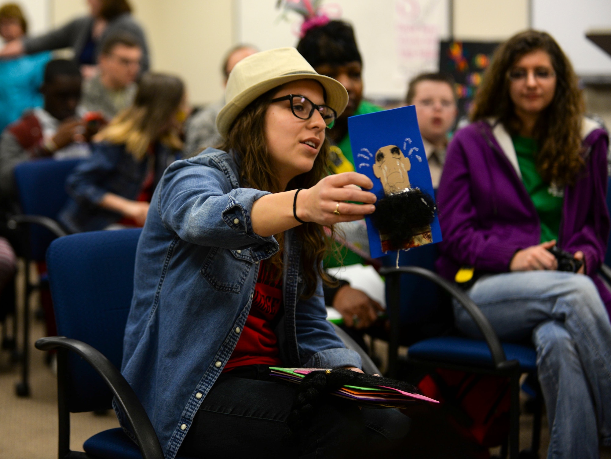 Chloe Brookings, a Georgia Military College World Literature Student, summarizes a piece of classic literature to Moody Youth Programs children during the Literacy Fair Feb. 26, 2015, at Moody Air Force Base, Ga. During the event, children enjoyed story time, displays, face painting and story-themed snacks. (U.S. Air Force photo by Senior Airman Sandra Marrero/Released)
