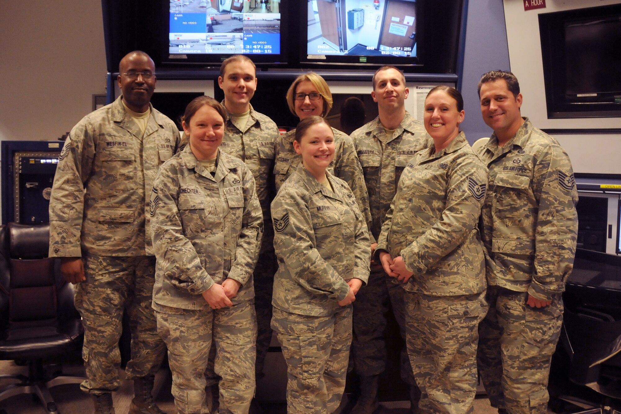 From left to right, back row, Master Sgt. Elijah Mesfin-El, Staff Sgt. Glenn Davis, Staff Sgt. Christina Krajcsovics, Tech. Sgt. Mike Primavera and Tech. Sgt. Michael Hickey, front row, Senior Master Sgt. Julie Schechter, Tech. Sgt. Katelyn Murphy and Tech. Sgt. Carly Lang, 108th Wing Command Post controllers, pose for a photo Feb. 8, 2015, at Joint Base McGuire-Dix-Lakehurst, N.J. Command post serves as the eye and ears of the wing commander. They work every day at all hours to receive and give messages for the entire wing. (U.S. Air National Guard Photo by Airman 1st Class Julia Pyun/Released)