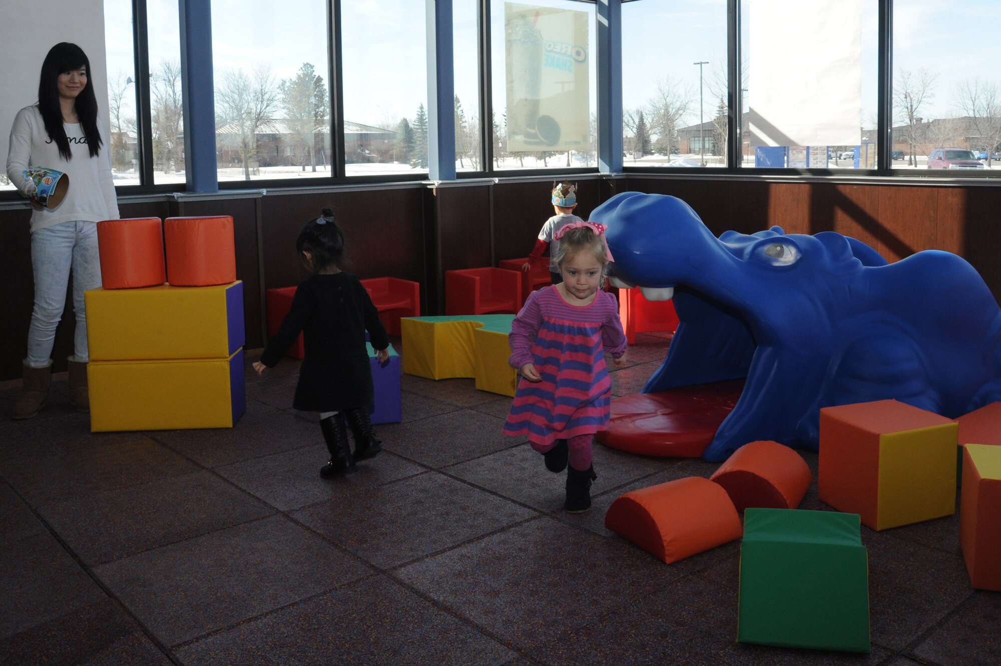 Children and parents enjoy the new toddler play area in the Burger King restaurant at the Exchange on Grand Forks Air Force Base, N.D., March 2, 2015. The play area is one of several new businesses and amenities that have recently come to the Grand Forks AFB Exchange. (U.S. Air Force photo/Staff Sgt. David Dobrydney)