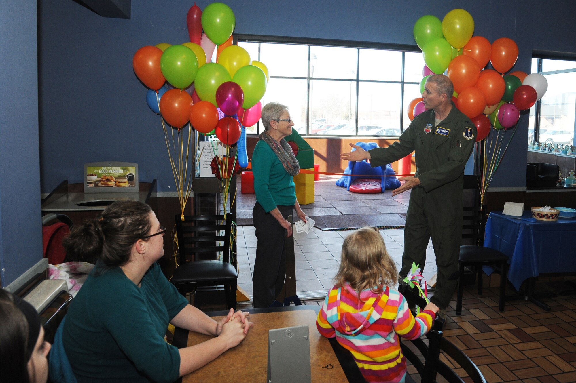 Col. Paul Bauman, 319th Air Base Wing commander, thanks Nancy Copada, Army & Air Force Exchange Service general manager for North Dakota, for her support in the creation of a new toddler play area in the Burger King restaurant on Grand Forks Air Force Base, N.D., March 2, 2015. The play area is one of several new businesses and services the Exchange is bringing to Grand Forks AFB. (U.S. Air Force photo/Staff Sgt. David Dobrydney)