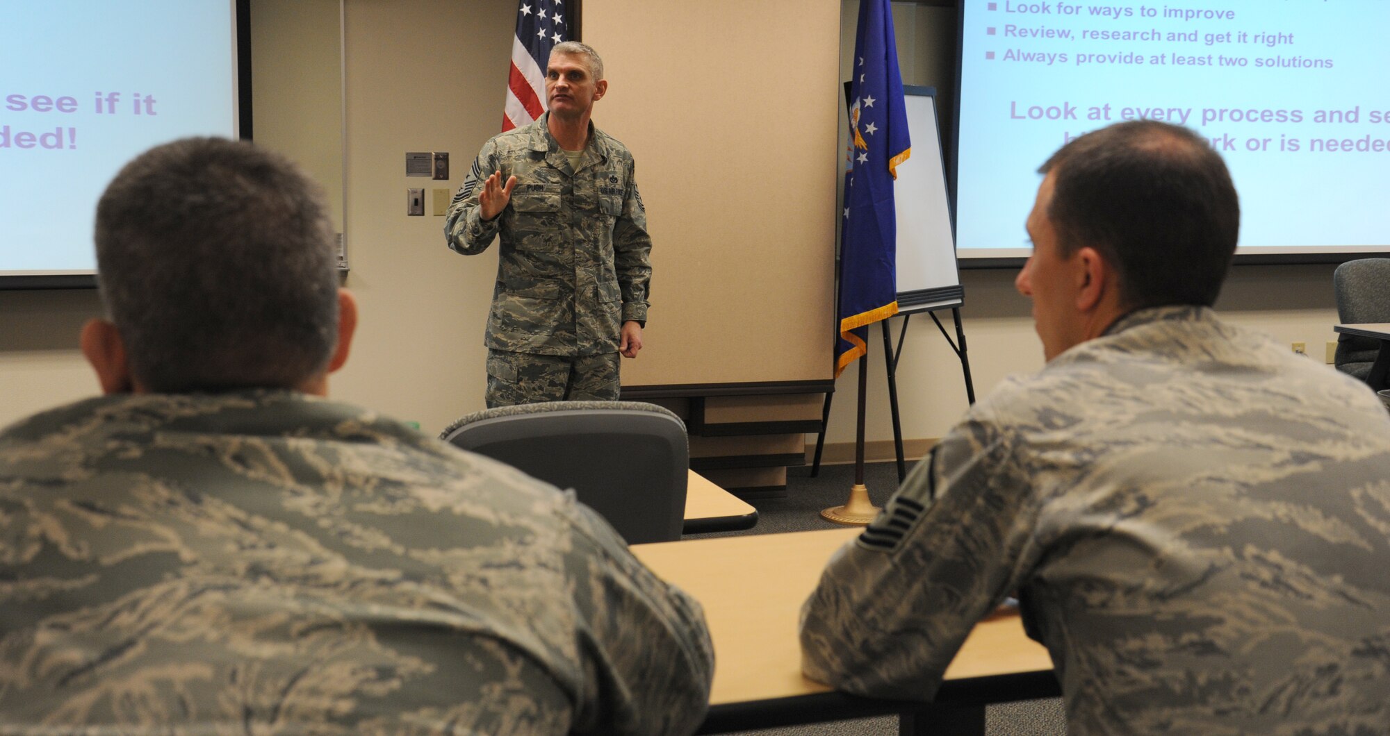 Airmen listen as Chief Master Sgt. Christian Pugh, 92nd Air Refueling Wing command chief talks about his five keys to leadership at the education center at Fairchild Air Force Base, Wash., February 18, 2015. Pugh encouraged Airmen to be familiar with Air Force instructions not only on the functional side, but also on the professional side. He also explained why it is important to be involved in a professional organization.  (U.S. Air Force photo/ Staff Sgt. Samantha Krolikowski) 