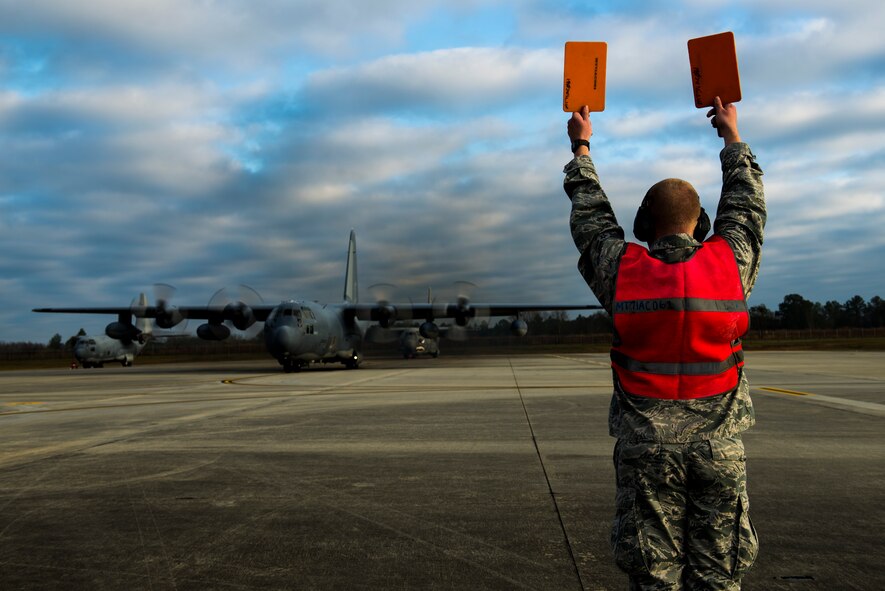U.S. Air Force Airman 1st Class Cameron Miller, 71st Aircraft Maintenance Unit crew chief, marshals aircraft 62-1863 ‘Iron Horse’, an HC-130P Combat King, before takeoff Mar. 3, 2015, at Moody Air Force Base, Ga. Iron Horse has been stationed at Moody since 2007 and is being flown to Davis-Monthan AFB, Ariz., for retirement. (U.S. Air Force photo by Airman 1st Class Dillian Bamman/Released)