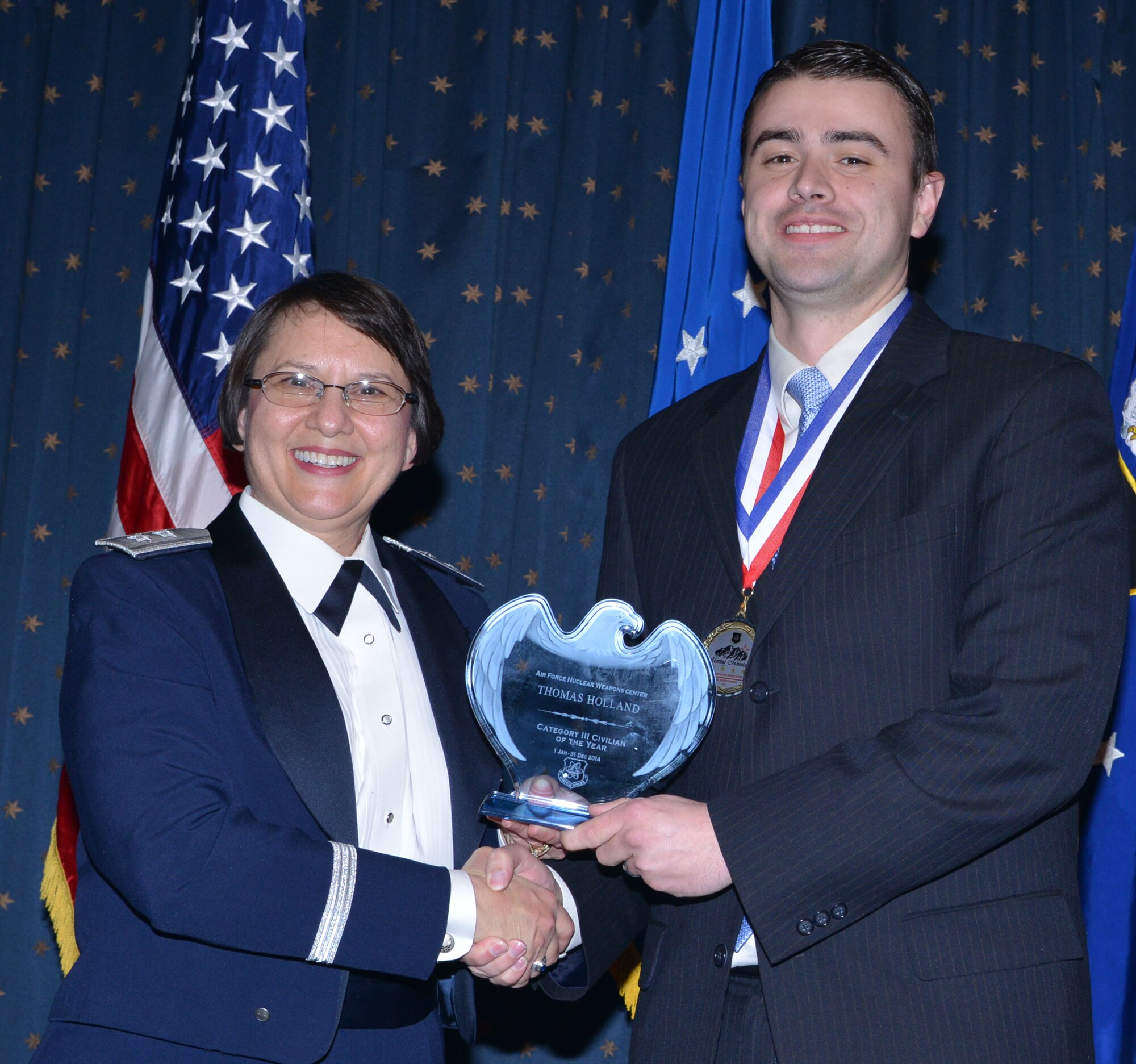 Thomas Holland, ICBM Systems, was named AFNWC Civilian (Category III) of the Year at an awards ceremony Feb. 27 at the Mountain View Club. Gen. Sandra Finan, Air Force Nuclear Weapons Center commander, presented the award. (Photo by Todd Berenger)