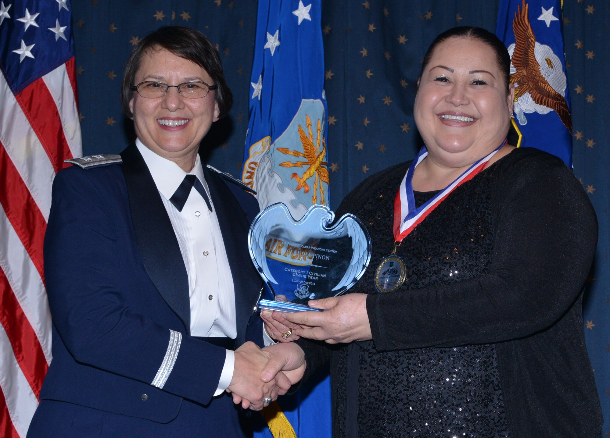 Claudia Pinon, 377th Medical Group, was named AFNWC Civilian (Category I) of the Year at an awards ceremony Feb. 27 at the Mountain View Club. Gen. Sandra Finan, Air Force Nuclear Weapons Center commander, presented the award. (Photo by Todd Berenger)
