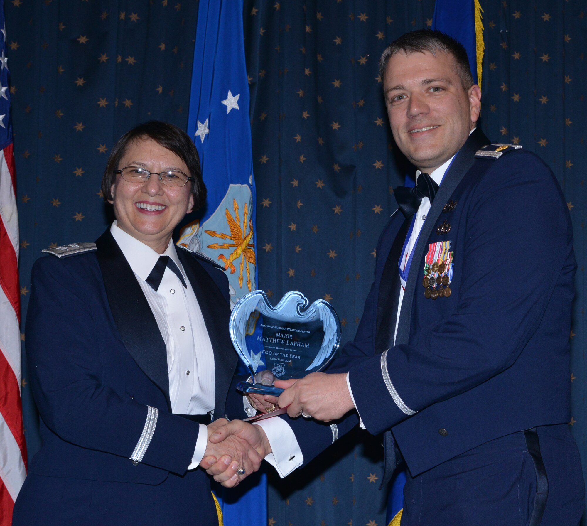 Maj. Matthew Lapham, Nuclear Capabilities Directorate, was named AFNWC FGO of the Year at an awards ceremony Feb. 27 at the Mountain View Club. Gen. Sandra Finan, Air Force Nuclear Weapons Center commander, presented the award. (Photo by Todd Berenger)