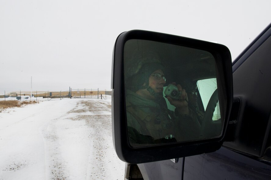 Airman 1st Class Patrick Boylan, 91st Missile Security Forces response force leader talks on the radio before performing a check on a launch facility in North Dakota, Feb. 12, 2015. Security forces have several layers of cold weather gear for warmth. The Humvees they travel in are heated, and they’re able to switch out if necessary so that individuals don’t have to stay in the cold for dangerously long periods of time. (U.S. Air Force photo/Senior Airman Brittany Y. Bateman)
