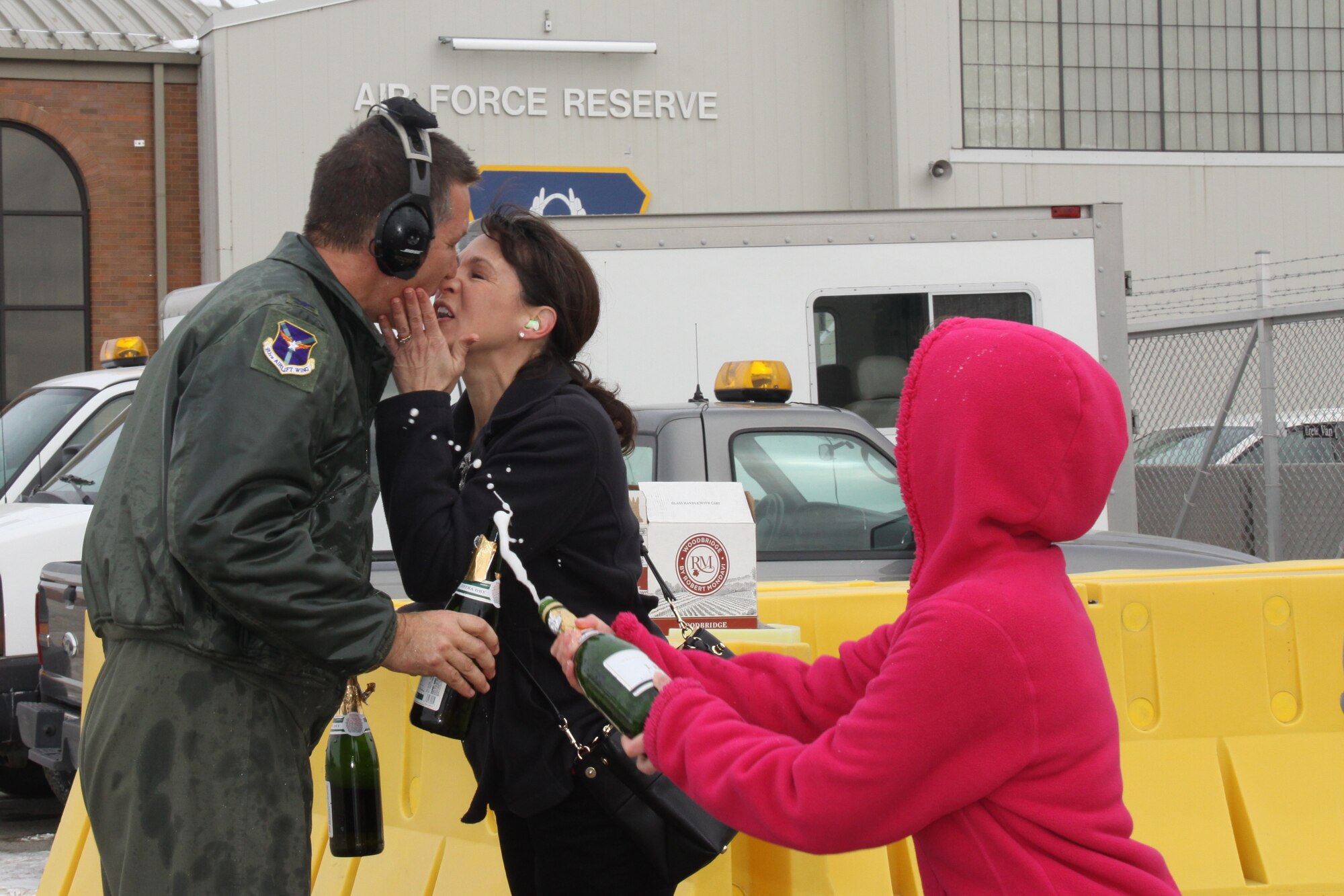 Col. Jeffrey Kozak, 911th Airlift Wing vice commander is congratulated by his wife and daughter upon landing from his C-130 Hercules final flight  with the 911th Airlift Wing during the February Unit Training Assembly Feb 7, 2015 at Pittsburgh International Airport Air Reserve Station, Pa. (U.S. Air Force photo by Maj. Jennifer Pearson)