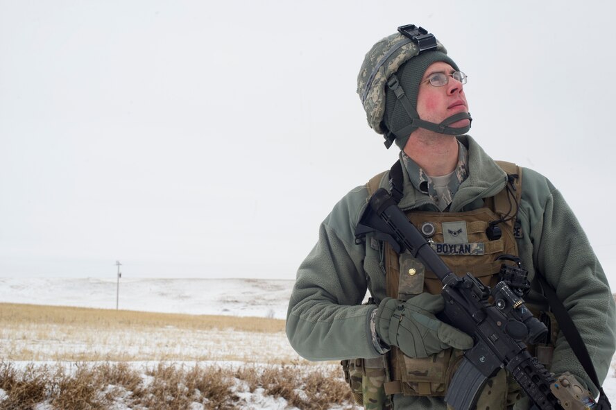 Airman 1st Class Patrick Boylan, 91st Missile Security Forces response force leader, performs an outer perimeter check on a launch facility in North Dakota, Feb. 12, 2015. Security forces have several layers of cold weather gear for warmth. (U.S. Air Force photo/Senior Airman Brittany Y. Bateman)