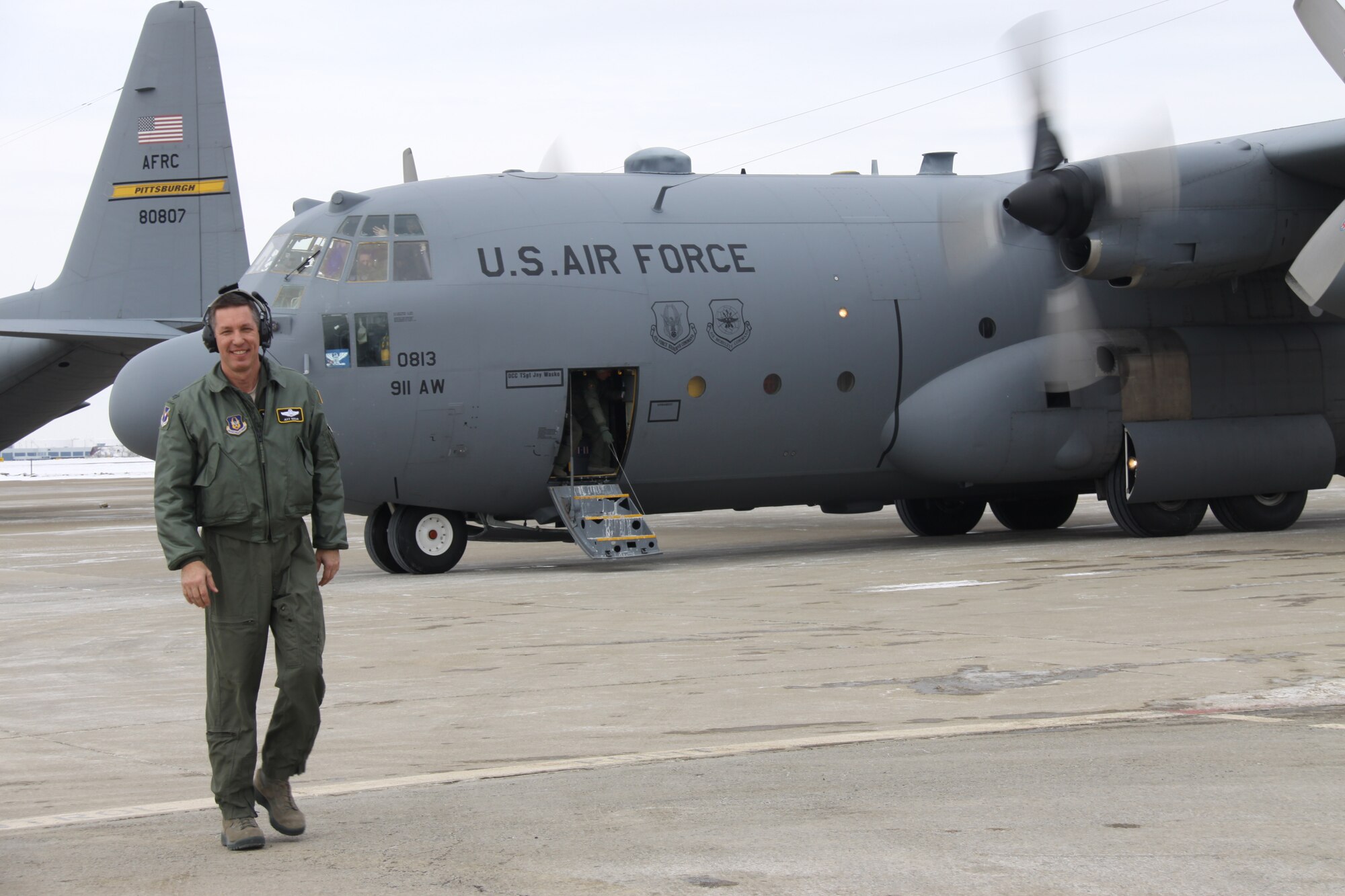 Col. Jeffrey Kozak, 911th Airlift Wing vice commander stands in front of the C-130 Hercules for his final C-130 flight with the 911th Airlift Wing during the February Unit Training Assembly Feb. 7, 2015, at Pittsburgh International Airport Air Reserve Station, Pa.. (U.S. Air Force photo by Maj. Jennifer Pearson)