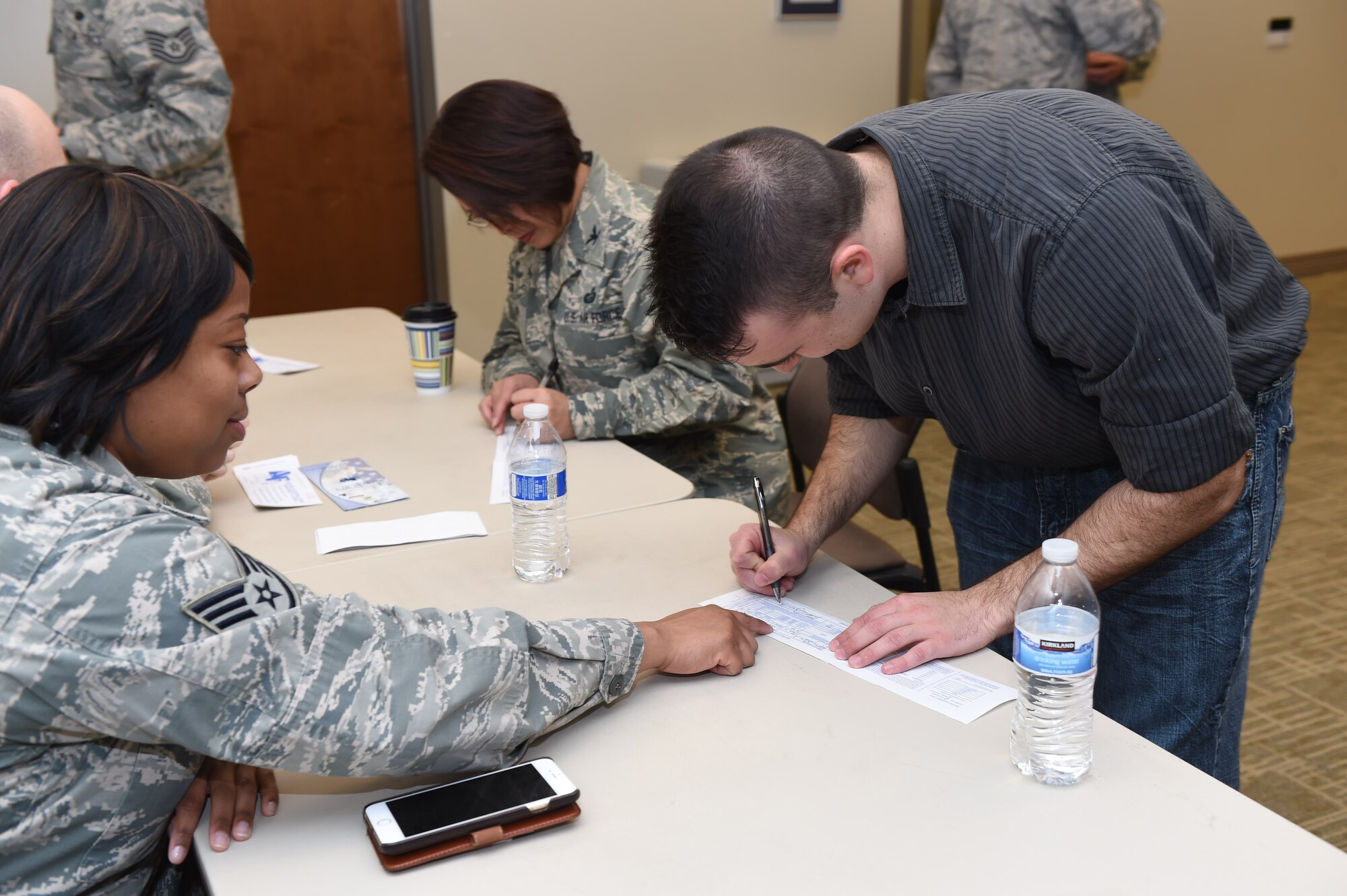 A Team Buckley member fills out a pledge card to donate to the Air Force Assistance Fund March 3, 2015, at the chapel on Buckley Air Force Base, Colo. The AFAF is designed to support Airmen and their families who are going through hardships such as family emergencies or financial troubles. (U.S. Air Force photo by Airman 1st Class Samantha Saulsbury/Released)