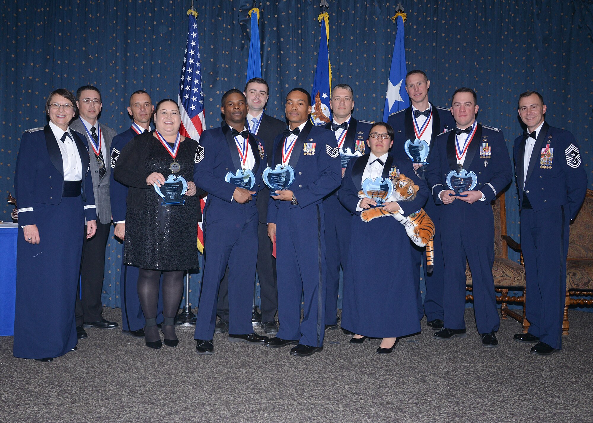 Congratulations to the Air Force Nuclear Weapons Center's 2014 Annual Award winners. Award recipients were recognized at an awards ceremony Feb. 27 at the Mountain View Club. From left to right: Maj. Gen. Sandra Finan, AFNWC commander; Robert Hopper, Civilian Category II; Senior Master Sgt. Joell Encalada, Senior NCO of the Year; Claudia Pinon, Civ Category I; Master Sgt. Wayne Sharp, First Sergeant of the Year; Thomas Holland, Civ Category III; Tech. Sgt. Daniel Key, NCO of the Year; Maj. Matthew Lapham, Field Grade Officer of the Year; Airman First Class Martha Dirton, Airman of the Year; Robert Eslinger, Civ Category IV (award accepted in his behalf by Maj. John Schantz); Capt. Spencer Turner, Company Grade Officer of the Year; and Chief Master Sgt. Brion Blais, AFNWC command chief. (Photo by Todd Berenger)