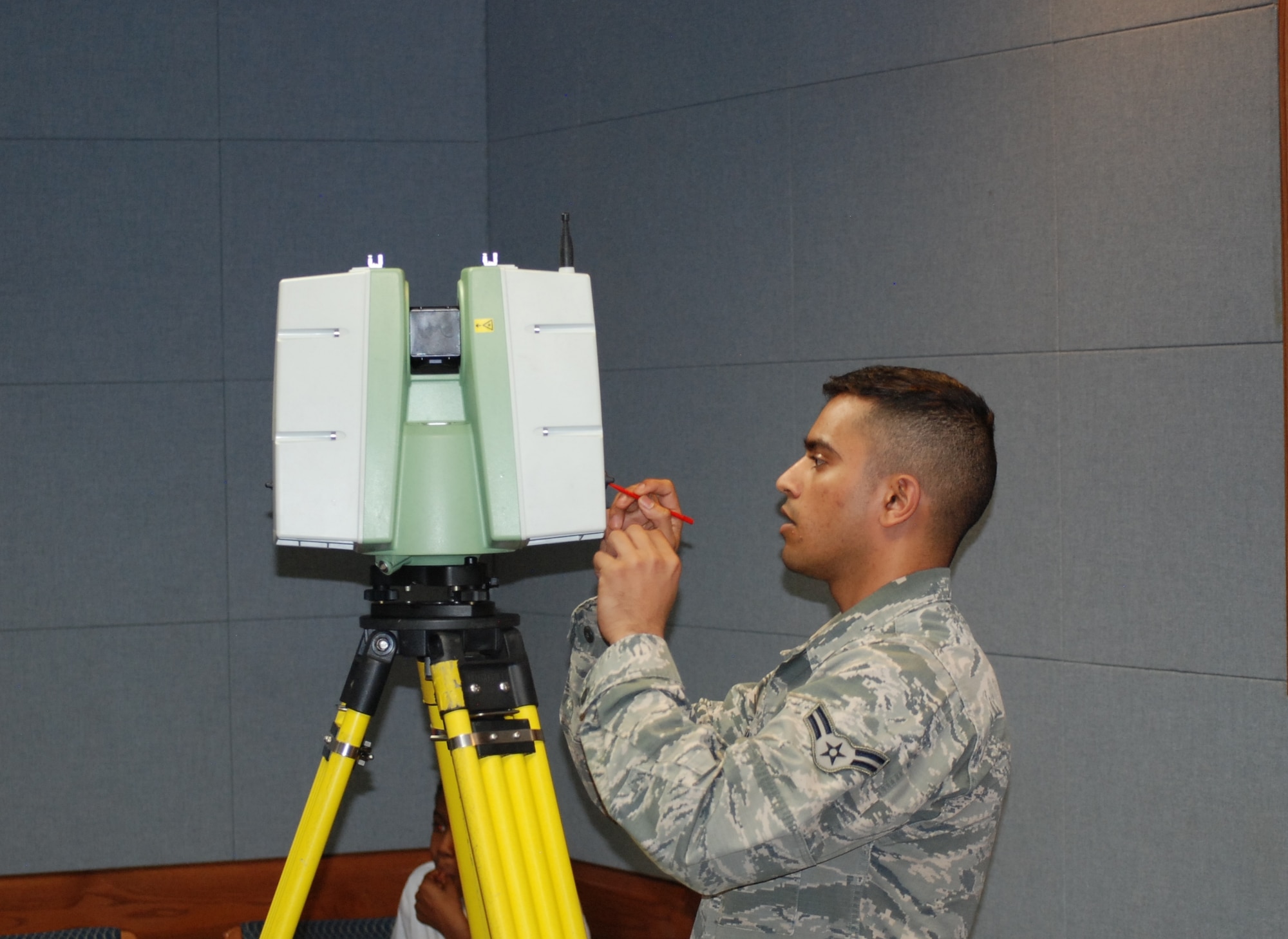 PETERSON AIR FORCE BASE, Colo. -- Airman 1st Class Nishant Thakar, 21st Civil Engineer Squadron, makes adjustments to the Leica C10 High Definition Survey Instrument. Peterson Air Force Base was the first in the Air Force to purchase the device, and the only other one is located at Nellis AFB. . The scanner creates images that can be used for maps, crisis management and other purposes more efficiently and accurately than similar GPS devices. (U.S. Air Force photo by Dave Smith)