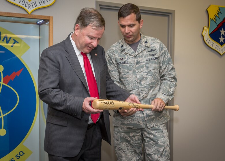 PETERSON AIR FORCE BASE, Colo. – Lt. Col. Roy Rockwell, 561st Network Operations Squadron commander, presents Rep. Doug Lamborn with a baseball bat during a visit to the 561st NOS Feb. 20. The signed bat will be encased on the squadron’s operations floor. The purpose of the visit was to introduce Lamborn to the Airmen of the 561st NOS and to brief him on the critical mission these men and women execute every day. (U.S. Air Force photo by Mary Dahlberg)