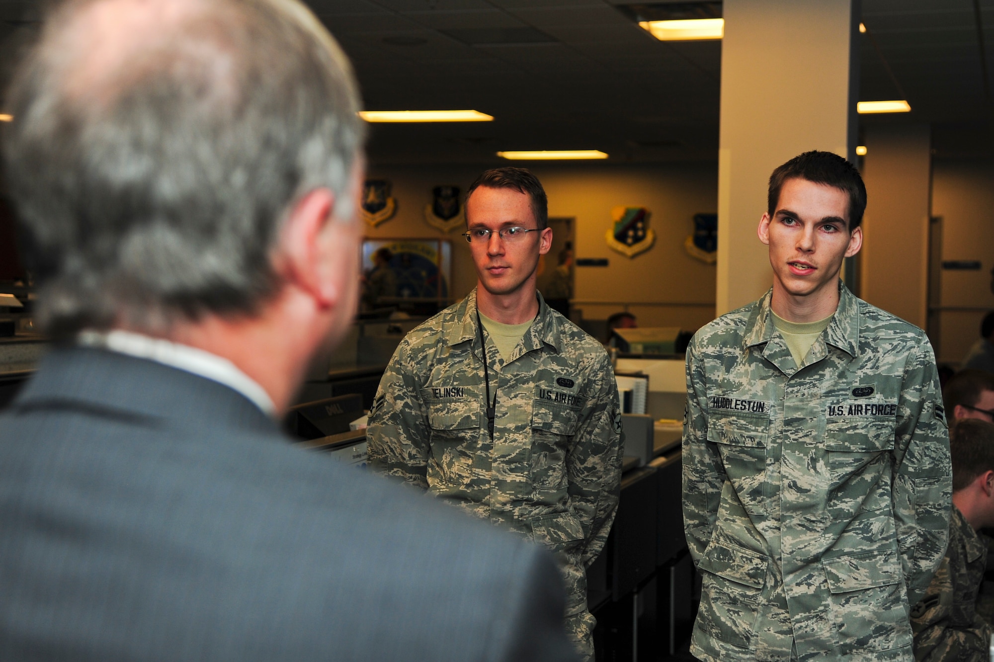 PETERSON AIR FORCE BASE, Colo. – Airman 1st Class Barry Zielinski, 561st Network Operations Squadron infrastructure technician (left), and Airman 1st Class Benjamin Huddlestun, 561st NOS boundary protection technician (right), describe the intricacies of their squadron’s daily mission to U.S. Rep. Doug Lamborn while on the operations floor Feb. 20. The purpose of the visit was to introduce Lamborn to the Airmen of the 561st NOS and to brief him on the critical mission these men and women execute every day. (U.S. Air Force photo by Staff Sgt. J. Aaron Breeden)