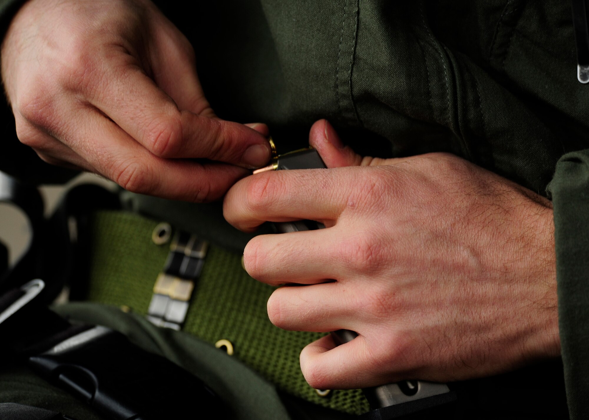 A Team Tyndall Airman loads his M9 pistol magazine Feb. 24 at the Combat Arms Training and Maintenance gun range. Every Airman has to load their own weapon while taking the CATM class. (U.S. Air Force photo by Airman 1st Class Solomon Cook/Released)