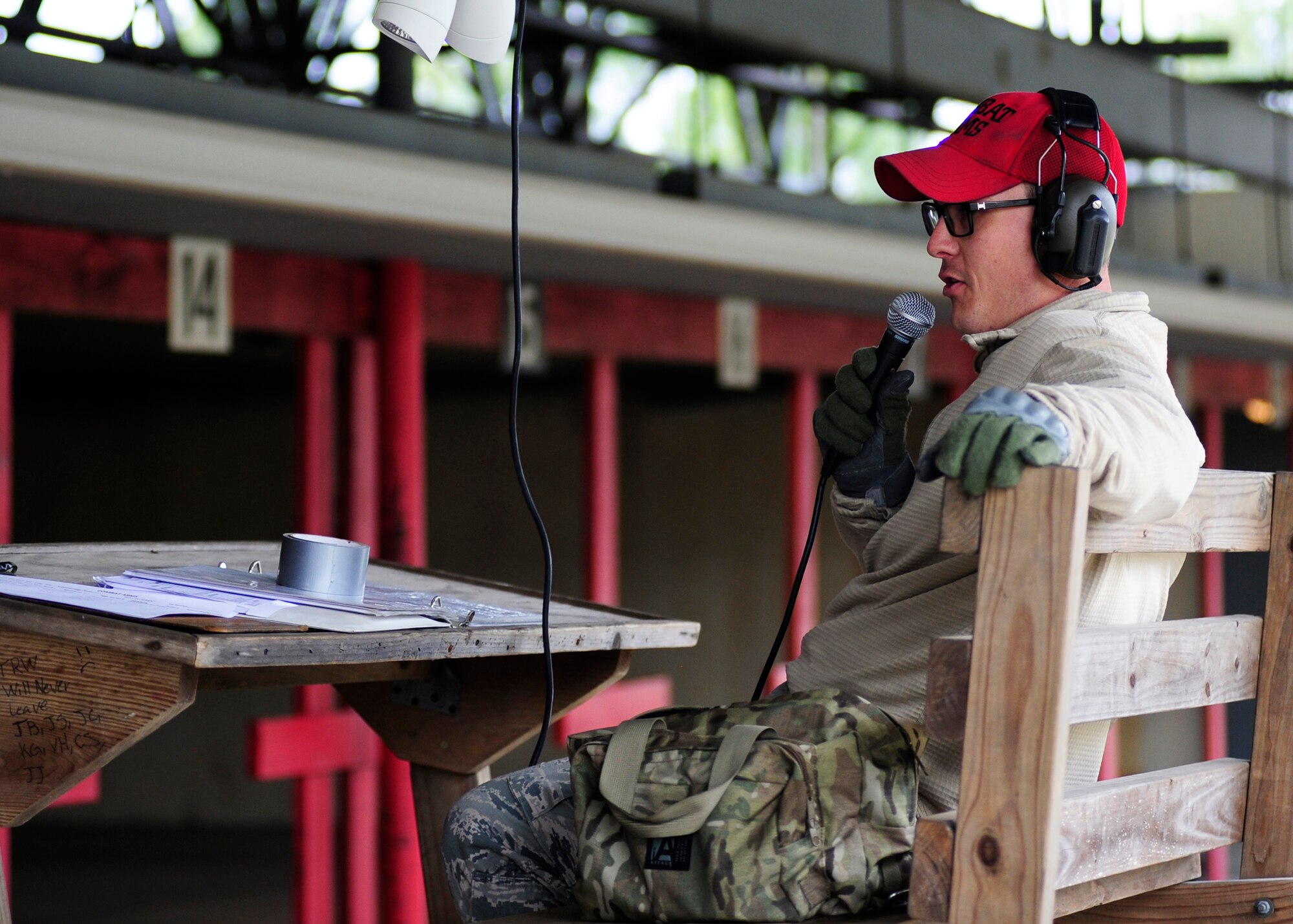 Staff Sgt. Joshua Jones, 325th Security Forces Squadron combat arms instructor, speaks into a microphone Feb. 23 at the Combat Arms Training and Maintenance gun range. As an instructor, he teaches Airmen and base personnel different weapon system and weapon safety. (U.S. Air Force photo by Airman 1st Class Solomon Cook/Released)