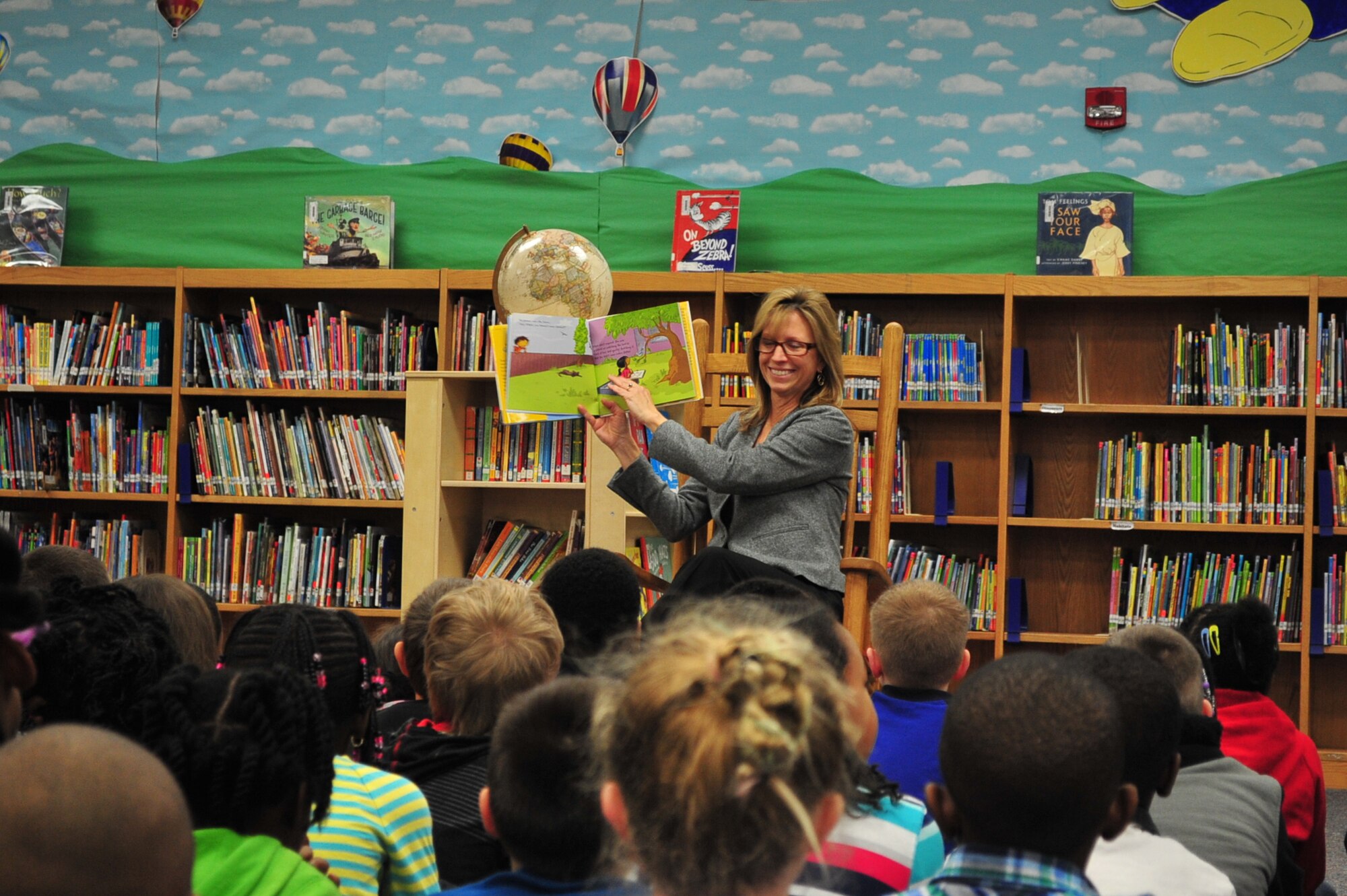 Sandra Polumbo, wife of U.S. Air Force Maj. Gen. H.D. Polumbo Jr., Ninth Air Force commander, reads a book to students at Shaw Heights Elementary School, Shaw Air Force Base, S.C., March 2, 2015. The Polumbos visited the school on Read Across America Day to encourage children to read and to raise awareness of the importance of a good education. (U.S. Air Force photo by Tech. Sgt. Ave I. Young/Released)