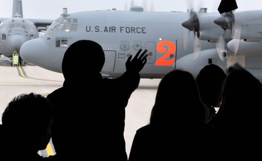 PETERSON AIR FORCE BASE, Colo. – Students participating in the Peterson AFB STARBASE program wave from the back of a C-130 aircraft to a taxiing C-130 on the runway here Feb. 25, 2015. More than 20 students spent the afternoon with the Air Force Reserve Command’s 302nd Airlift Wing Airmen to learn about their missions and to tour a C-130 aircraft. According to their official website, “STARBASE students participate in challenging ‘hands-on, mind-on’ activities in Science, Technology, Engineering, and Math. They interact with military personnel to explore careers and observe STEM applications in the real world. The program provides students with 25 hours of experiences at bases across the nation.” (U.S. Air Force photo/Master Sgt. Daniel Butterfield)