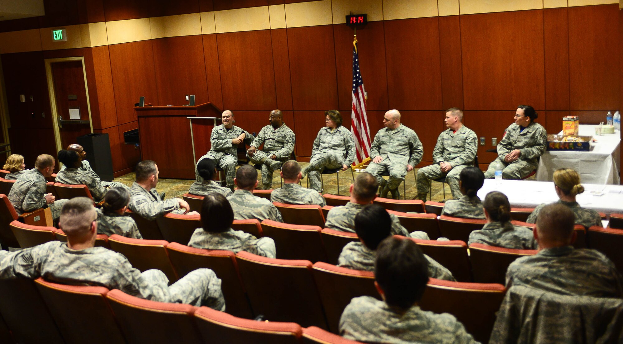 Six first sergeants share their knowledge and experience with 30 junior and senior NCOs about the roles and responsibilities as part of a symposium at the Deployment Center auditorium at Ellsworth Air Force Base, S.D., Feb. 20, 2015. The symposium allowed attendees to interact with one another and ask the panel questions about the challenges of being first sergeants. (U.S. Air Force photo by Airman 1st Class Zachary Hada/Released)