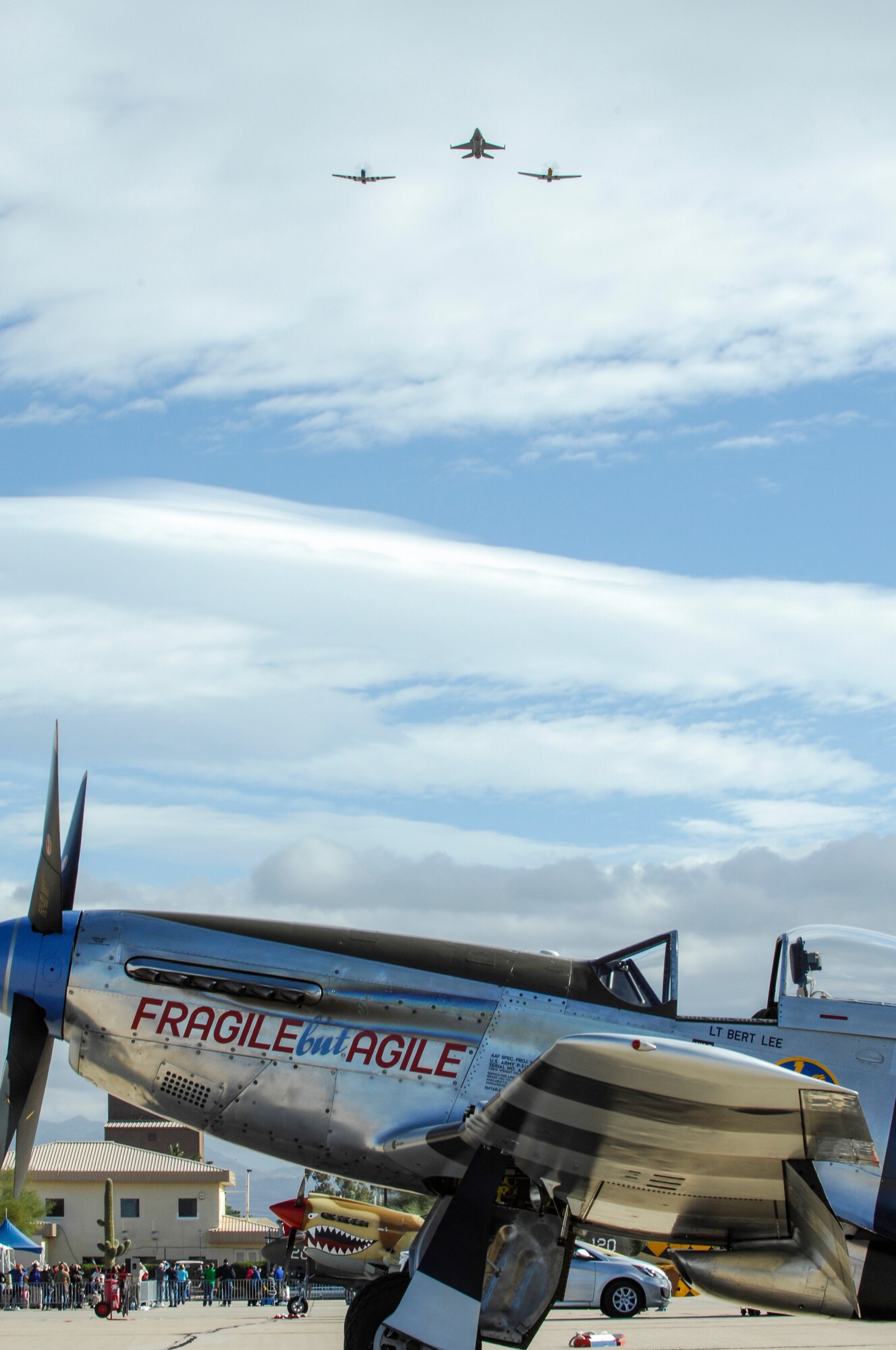 Two P-51 Mustangs and an F-16 Fighting Falcon (center) perform a fly over during the Heritage Flight Training and Certification Course at Davis-Monthan Air Force Base, Ariz., Feb. 28, 2015. The aircraft that participated in this year’s HFTCC were the historic P-51 Mustang, P-40 Warhawk, P-38 Lightning, P-47 Thunderbolt and F-86 Sabre. ACC aircraft included the F-22 Raptor and the F-16 Fighting Falcon. (U.S. Air Force photo by Airman 1st Class Cheyenne Morigeau/Released)