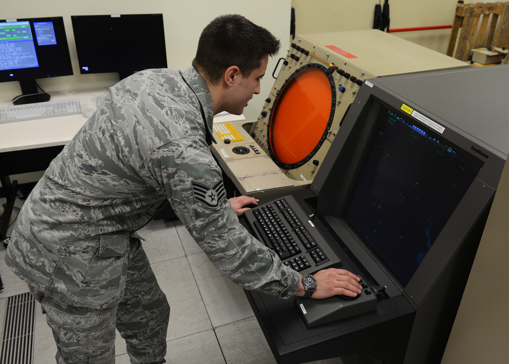 U.S. Air Force Staff Sgt. Nicholas Krug, 31st Operations Support Squadron ground radar systems technician, performs a daily check on the newly installed Digital Airport Surveillance Rader system next to the old ASR system, Feb. 12, 2014, at Aviano Air Base, Italy. The new system provides more reliable and accurate radar readings, while giving controllers clearer, high-definition screens to decipher exact aircraft locations. (U.S. Air Force photo by Airman 1st Class Deana Heitzman/Released)