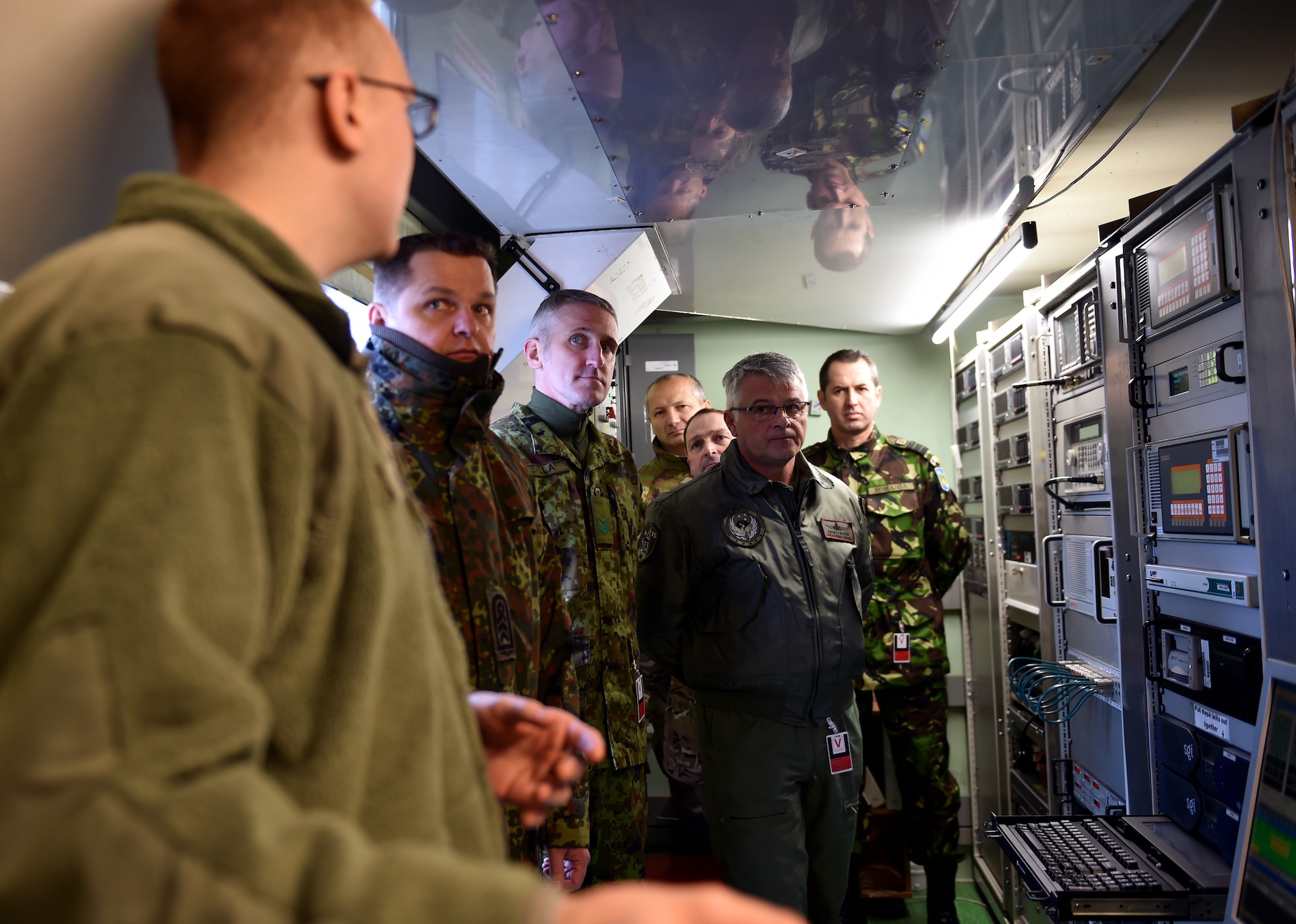 Senior Airman Logan Hyde, 24th Intelligence Squadron data acquisition segment operator, explains the capabilities of the Eagle Vision One program to a group of enlisted leaders from six different nations’ air forces throughout Europe at Ramstein Air Base, Germany, Feb. 23, 2015. The group of enlisted leaders included the chief master sergeant of the Romanian and Estonian air forces and other leaders from the German, Italian, Slovenian and the United Kingdom’s air forces visited Ramstein before attending the Kaiserslautern Military Community First Sergeant Council's First Sergeant Symposium. (U.S. Air Force photo/Staff Sgt. Sara Keller)