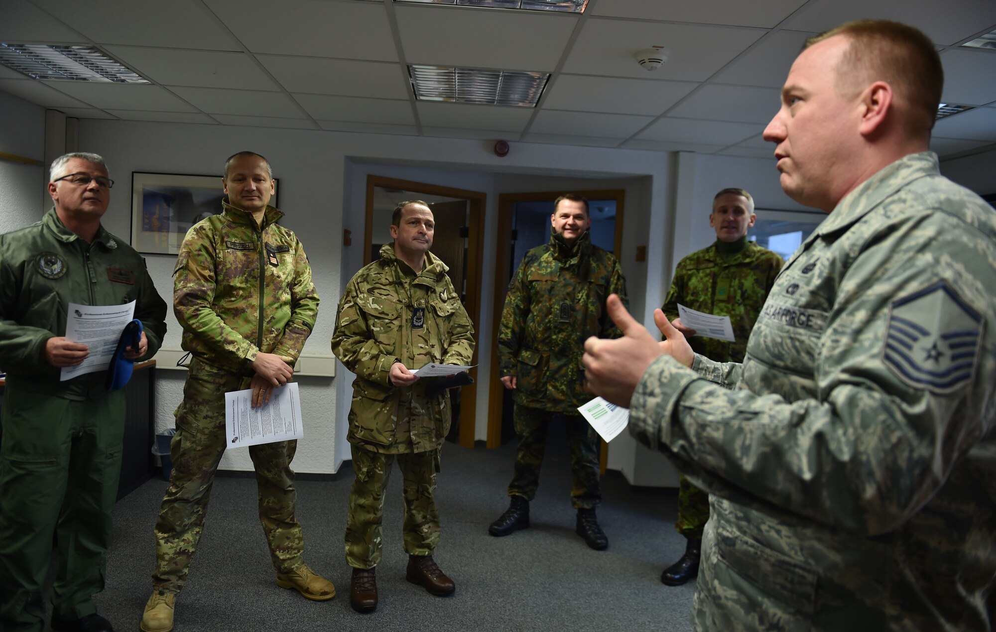Master Sgt. Etienne Tousignant, 86th Force Support Squadron career assistance advisor, briefs a group of enlisted leaders from six different nations’ air forces throughout Europe about the professional enhancement center and First Term Airman Center at Ramstein Air Base, Germany, Feb. 23, 2015. The group of enlisted leaders included the chief master sergeant of the Romanian and Estonian air forces and other leaders from the German, Italian, Slovenian and the United Kingdom’s air forces visited Ramstein before attending the Kaiserslautern Military Community First Sergeant Council's First Sergeant Symposium. (U.S. Air Force photo/Staff Sgt. Sara Keller) 