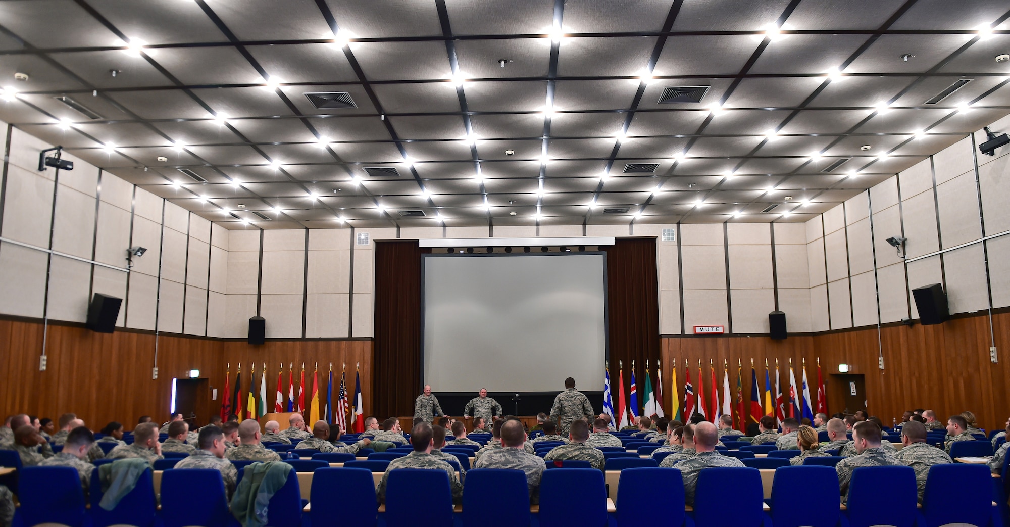 Approximately 120 students listen as one student asks a question during the Kaiserslautern Military Community First Sergeant Council's First Sergeant Symposium at Einsiedlerhof, Germany, Feb. 26, 2015. A group of enlisted leaders including the chief master sergeant of the Romanian and Estonian air forces and other leaders from the German, Italian, Slovenian and the United Kingdom’s air forces visited Ramstein before attending the First Sergeant Symposium. (U.S. Air Force photo/Staff Sgt. Sara Keller)