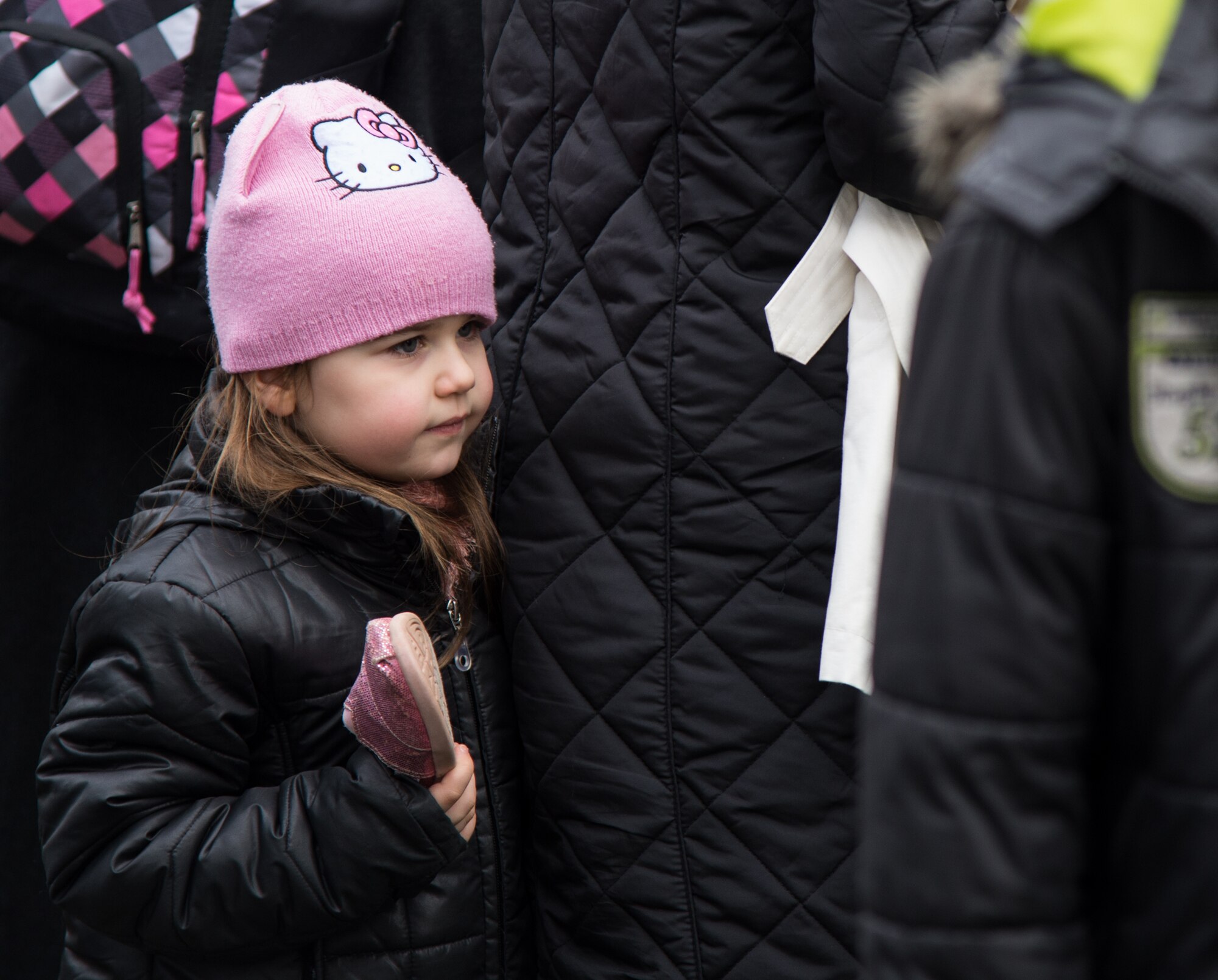 A child holds a shoe she found at a food and clothing drive Feb. 21, 2015, in Kaiserslautern, Germany. More than 1,500 pounds of bread and clothing were donated to approximately 100 people in the local community. Service members from Ramstein Air Base, and the Kaiserslautern Military Community joined together to volunteer for the food and clothing drive. (U.S. Air Force photo/Senior Airman Jonathan Stefanko)