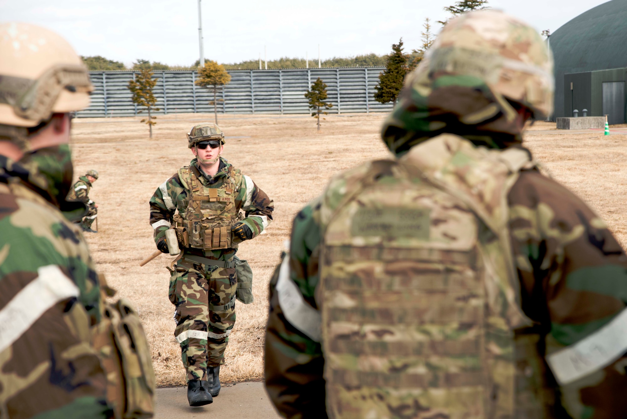 Airman 1st Class Thomas Cuff, 35th Civil Engineer Squadron Explosive Ordnance Disposal technician, reports to 35 CES EOD supervisors Staff Sgt. Warren Long and Staff Sgt. Matthew Morris, after marking a detonation site March 5, 2015, at Misawa Air Base, Japan. The Misawa EOD team destroyed about a dozen unexploded ordnance during an operational readiness exercise that injected a scenario that temporarily shut down the airfield. (U.S. Air Force photo by Staff Sgt. Derek VanHorn)