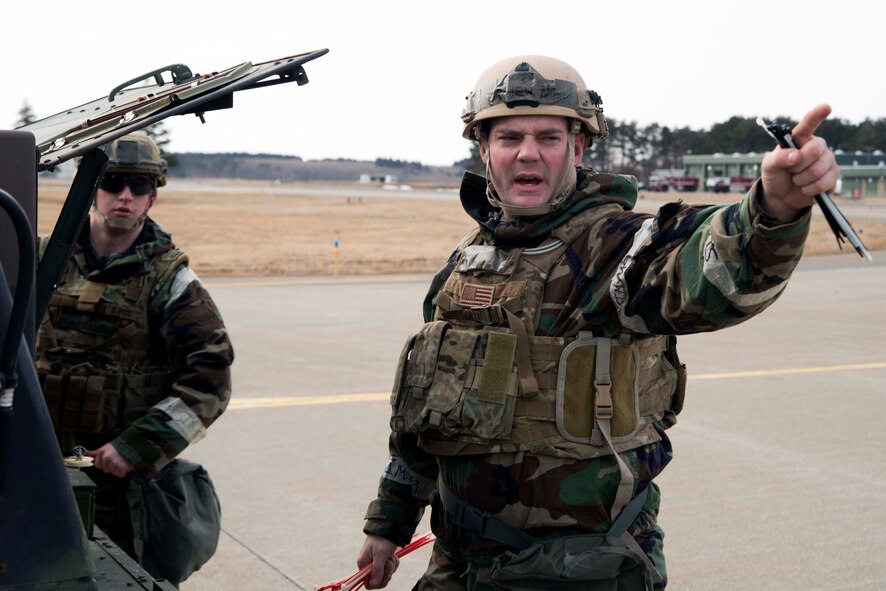 Staff Sgt. Matthew Morris, right, 35th Civil Engineer Squadron Explosive Ordnance Disposal technician, identifies a detonation location to Airman 1st Class Thomas Cuff, 35 CES EOD tech, during an operational readiness exercise March 3, 2015, at Misawa Air Base, Japan. The EOD team is the only qualified team on base to dispose of unexploded ordnance. (U.S. Air Force photo by Staff Sgt. Derek VanHorn)