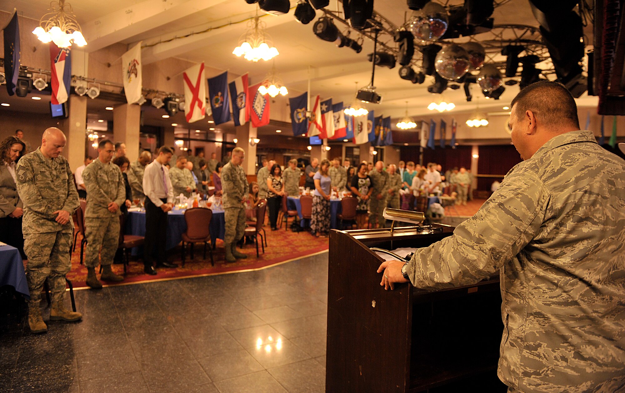 U.S. Air Force Capt. Craig Nakagawa, 18th Wing Chaplain Corps chaplain, blesses the beginning of Kadena's National Prayer Luncheon at the Rocker NCO Club on Kadena Air Base, Japan, Feb. 25, 2015. The National Prayer Luncheon dates back to the 1930s when civic and business leaders came together to share a meal, study the Bible and develop relationships of trust and support. (U.S. Air Force photo by Naoto Anazawa)