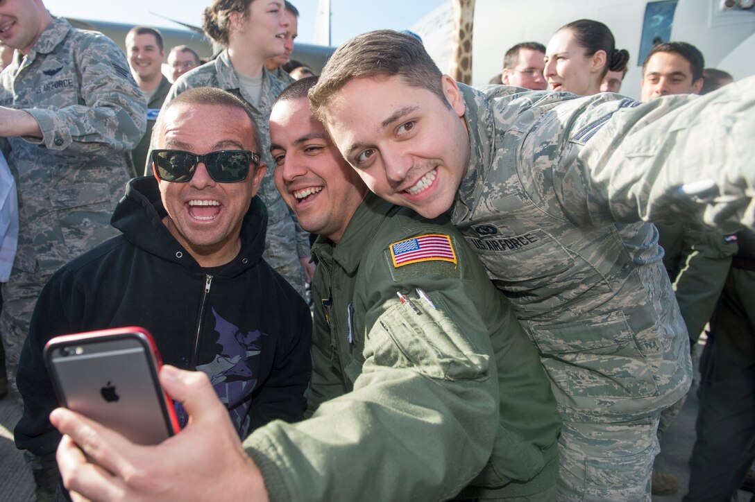 U.S. service members take selfies with actor Jason "Wee Man" Acuna, who joined the Navy Adm. James A. Winnefeld, Jr., vice chairman of the Joint Chiefs of Staff, for a USO show on Ramstein Air Base, Germany, March 3, 2015.