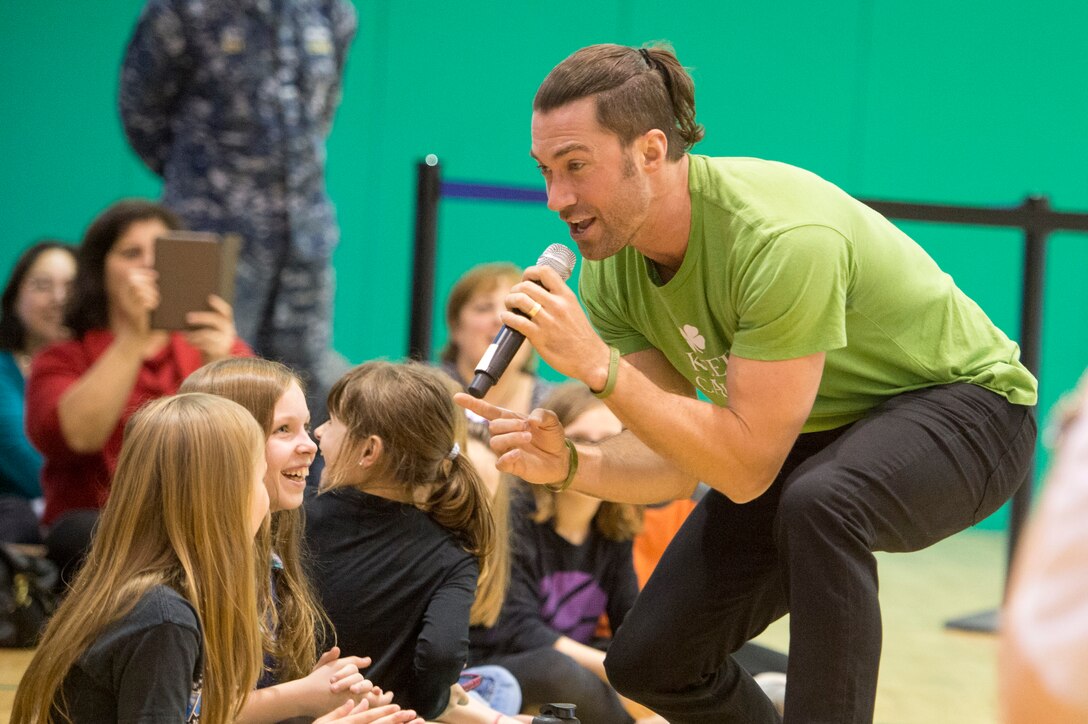 Singer Ace Young entertains children during the USO tour in Naples, Italy, March 3, 2015. Singer Phillip Phillips, Jason "Wee Man" Acuna, NFL quarterback Andrew Luck, Pittsburgh Steelers guard David DeCastro, Indianapolis Colts tight end Dwayne Allen, singer Diana DeGarmo, actor Dennis Haysbert, Miss America Kira Kazantsev, Indianapolis Colts head coach Chuck Pagano and singer Ace Young also participated in the tour.