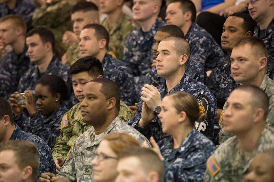 U.S. troops listen as celebrities perform during the USO tour in Naples ...