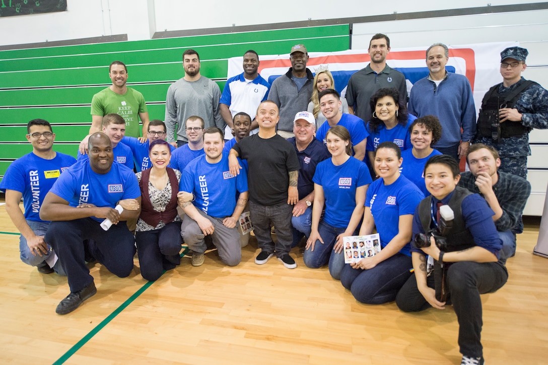 Celebrities and athletes participating in the USO tour pose for a photo in Naples, Italy, March 3, 2015.