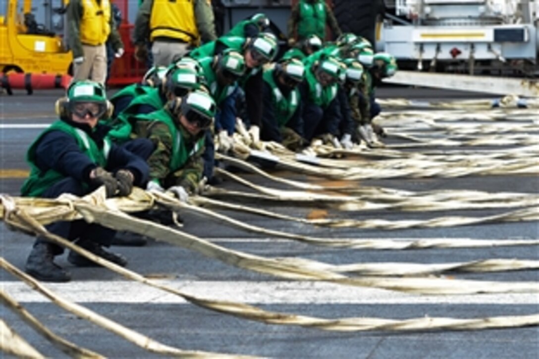 Sailors participate in a barricade drill on USS John C. Stennis’ flight deck in Bremerton, Wash., March 2, 2015. The Stennis is currently undergoing an operational training period in preparation for future deployments. 