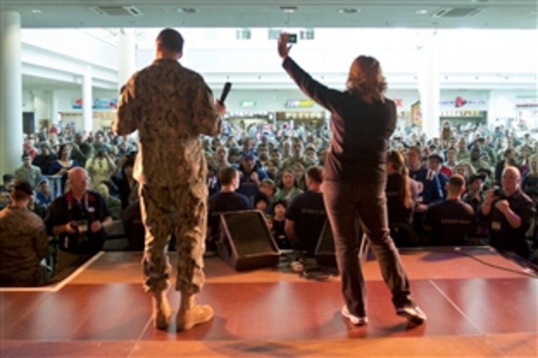 U.S. Navy Adm. James A. Winnefeld Jr., vice chairman of the Joint Chiefs of Staff, and his wife, Mary, wave on stage during a USO concert on Ramstein Air Base, Germany, March 3, 2015. Winnefeld is hosting a USO tour to provide cheer for service members serving around the world. The tour runs through March 9, 2015.