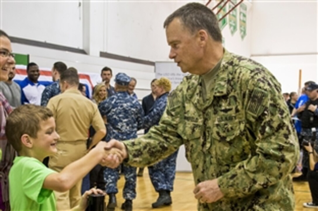 U.S. Navy Adm. James A. Winnefeld Jr., vice chairman of the Joint Chiefs of Staff, shakes hands with a boy after a USO concert in Naples, Italy, March 3, 2015. Winnefeld is hosting a USO tour to provide cheer for troops serving around the world. The tour runs through March 9, 2015.
