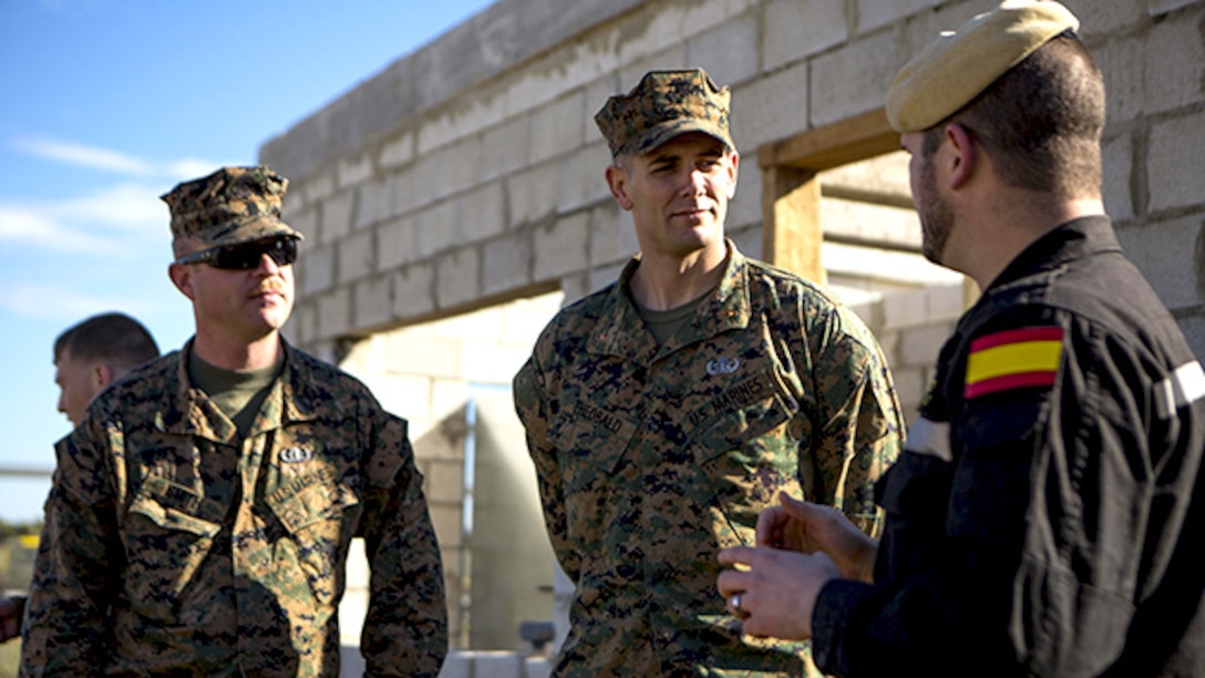 U.S. Marine Corps Warrant Officer Ahbleza Theobald, center, an explosive ordnance disposal technician with Special-Purpose Marine Air-Ground Task Force Crisis Response-Africa, discusses future joint training opportunities with Cabo Primero Antonio Diosdado, right, a Spanish Defense Force public affairs representative with Unidad Militar de Emergencias, an emergency response force, at Morón Air Base, Spain, Feb. 18., 2015. Bi-lateral training exercises between the partner nations provide unique opportunities for the service members to learn from each other and develop the ability to operate as a cohesive team. (U.S. Marine Corps photograph by Lance Cpl. Christopher Mendoza/Released)