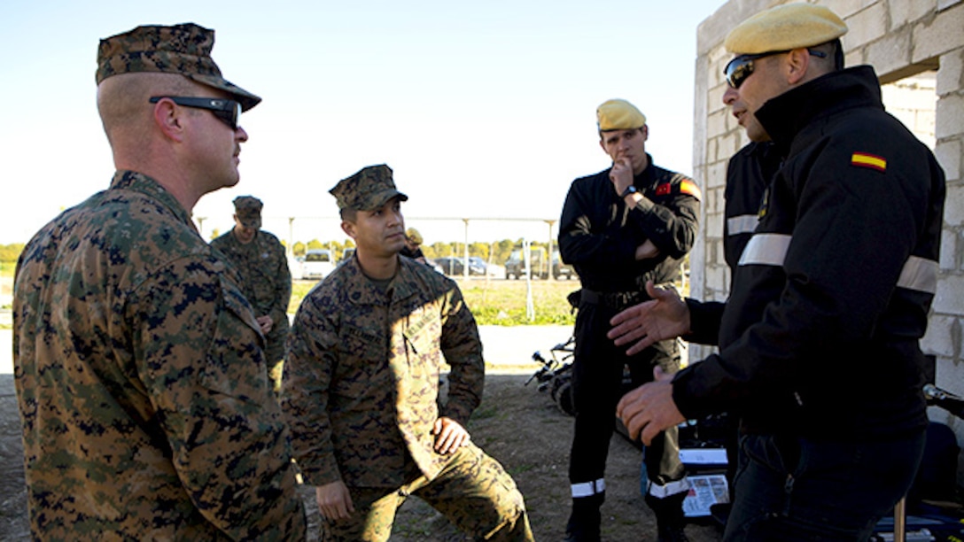 U.S. Marine Corps explosive ordnance disposal technicians with Special-Purpose Marine Air-Ground Task Force Crisis Response-Africa discuss their various mission capabilities and future joint training opportunities with the Spanish Defense Force’s Unidad Militar de Emergencias, an emergency response unit, at Morón Air Base, Spain, Feb. 18, 2015. Joint training provides the Marines and Spanish forces opportunities to further their capabilities by cross training and learning to operate as a cohesive team. (U.S. Marine Corps photograph by Lance Cpl. Christopher Mendoza/Released)