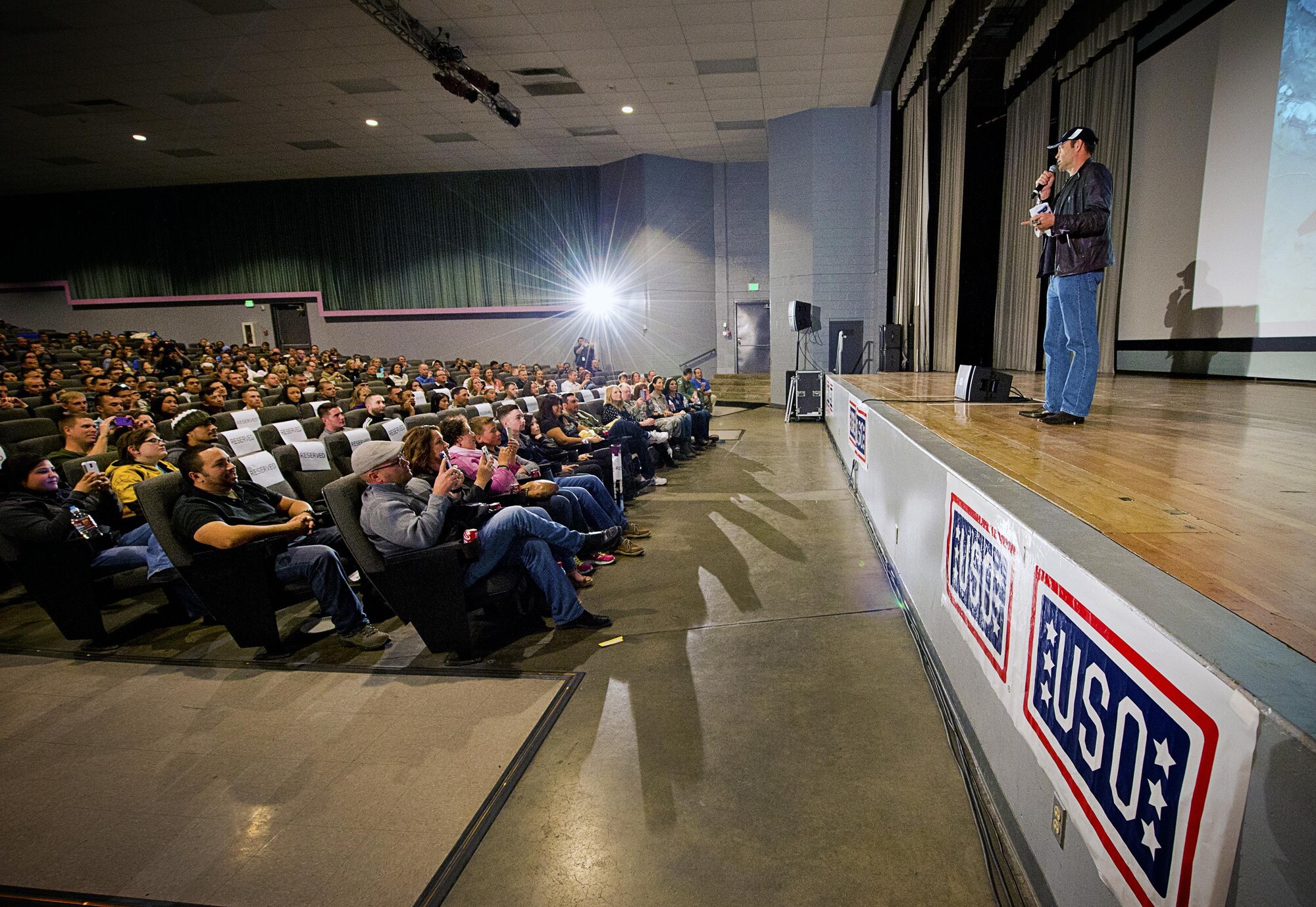 Actor Vince Vaughn talks to a packed audience before premiering his new film, “Unfinished Business,” Feb. 28, 2015, in the base theater at Edwards Air Force Base, Calif. Vaughn treated troops and their families to an advance screening of the film as part of his third USO visit. (USO photo/Dave Gatley)