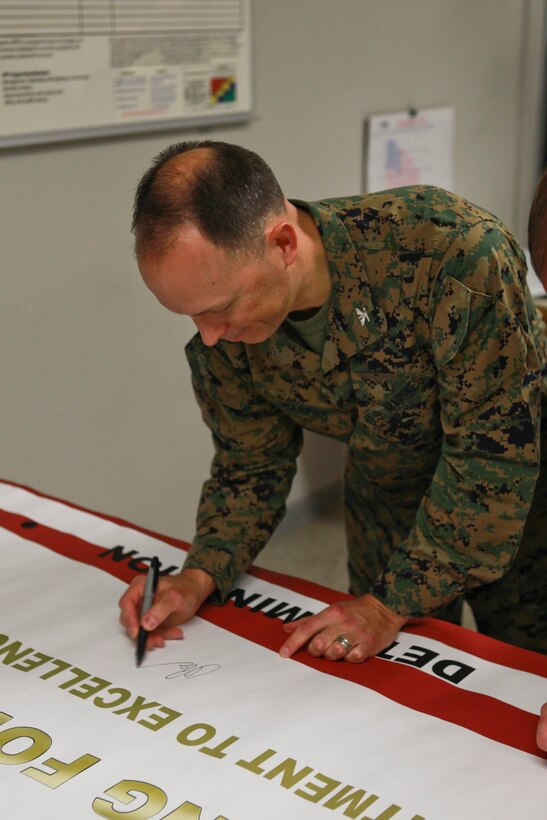U.S. Marine Corps Col. Chris Pappas III Commanding Officer Marine Corps Air Station Cherry Point autographs a banner for the introduction of the Voluntary Protection Program (VPP) MCAS Cherry Point N.C., Jan. 14, 2015.  VPP, facilitates change in safety culture. The goal is to create a proactive work environment to reduce mishaps and preserve limited resources, both personnel and property.
(U.S. Marine Corps photo by Lance Cpl Colin Broadstone/ Released)