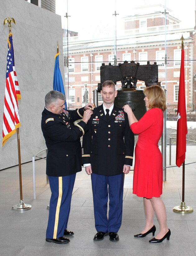 U.S. Army Corps of Engineers' Philadelphia District Deputy Commander Andrew Yoder was promoted to the rank of Lieutenant Colonel during a March 4, 2015 ceremony at the Liberty Bell. Col. Marc Ferraro (left), Acting Deputy Adjutant General of the Pennsylvania National Guard, and Yoder's wife, Nikki, pinned the rank on LTC Yoder. 