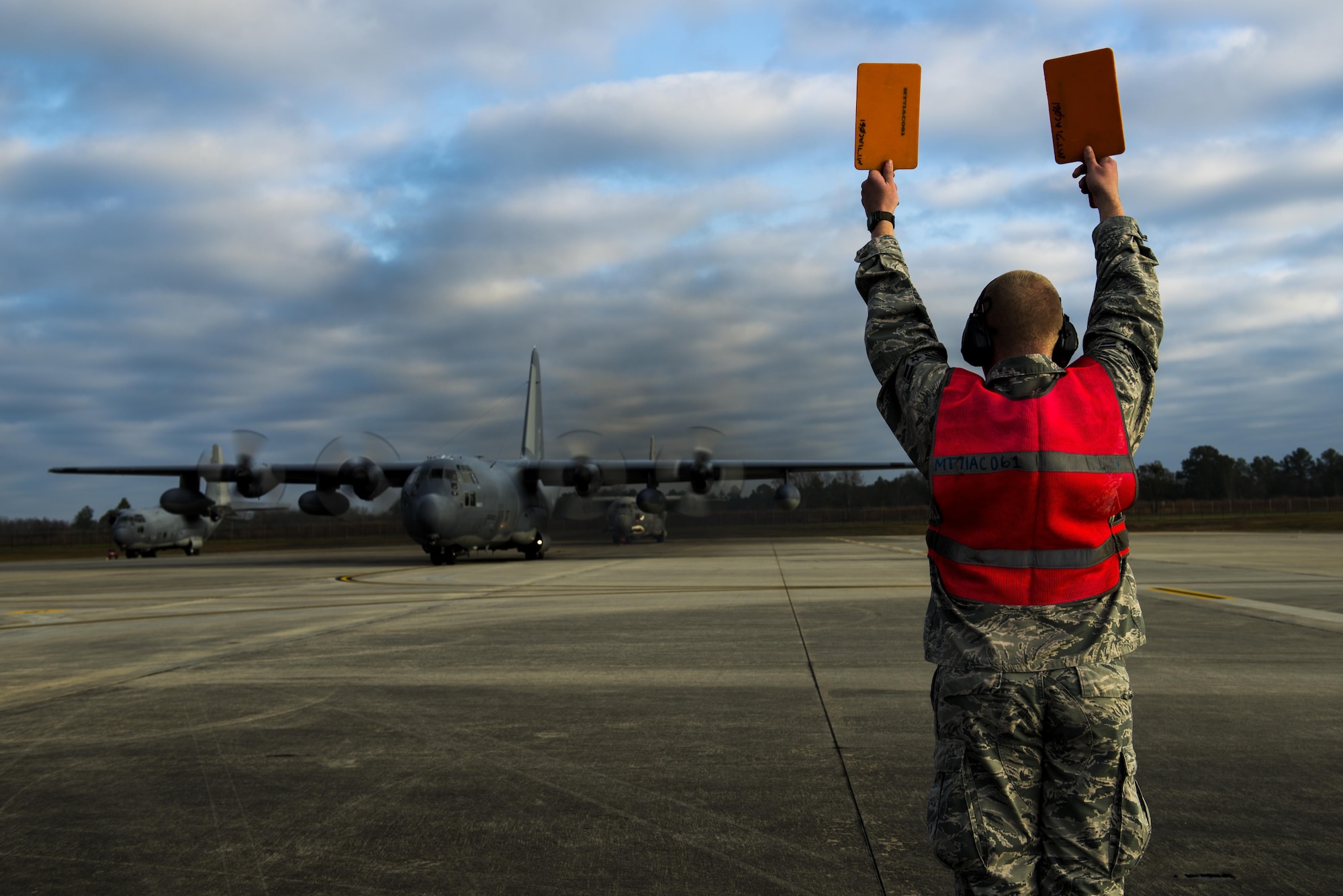Airman 1st Class Cameron Miller marshals aircraft 62-1863 ‘Iron Horse’, an HC-130P Combat King, before takeoff Mar. 3, 2015, at Moody Air Force Base, Ga. Iron Horse has been stationed at Moody AFB since 2007 and is being flown to Davis-Monthan AFB, Ariz., for retirement. Miller is a 71st Aircraft Maintenance Unit crew chief. (U.S. Air Force photo/Airman 1st Class Dillian Bamman)