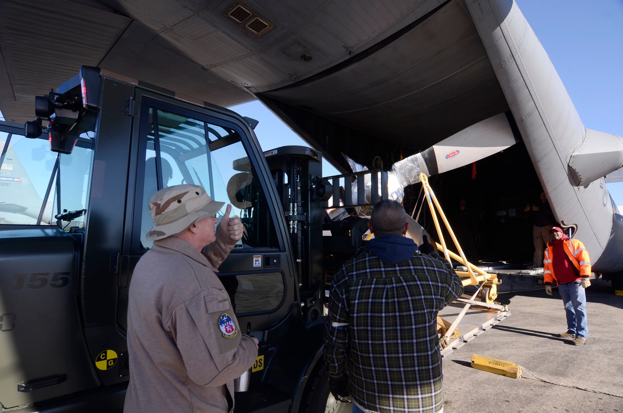 Members of the 94th Logistics Readiness Squadron, Dobbins Air Reserve Base, Ga. prepare and load cargo required by deployed personnel Jan. 6, 2015. Personnel appointed as inspector observe all aspects of the loading process ensuring all proper procedures are followed. (U.S. Air Force photo/Don Peek)